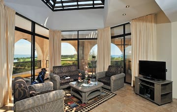 a living room with a glass roof and a television