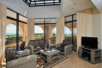 a living room with a glass roof and a television