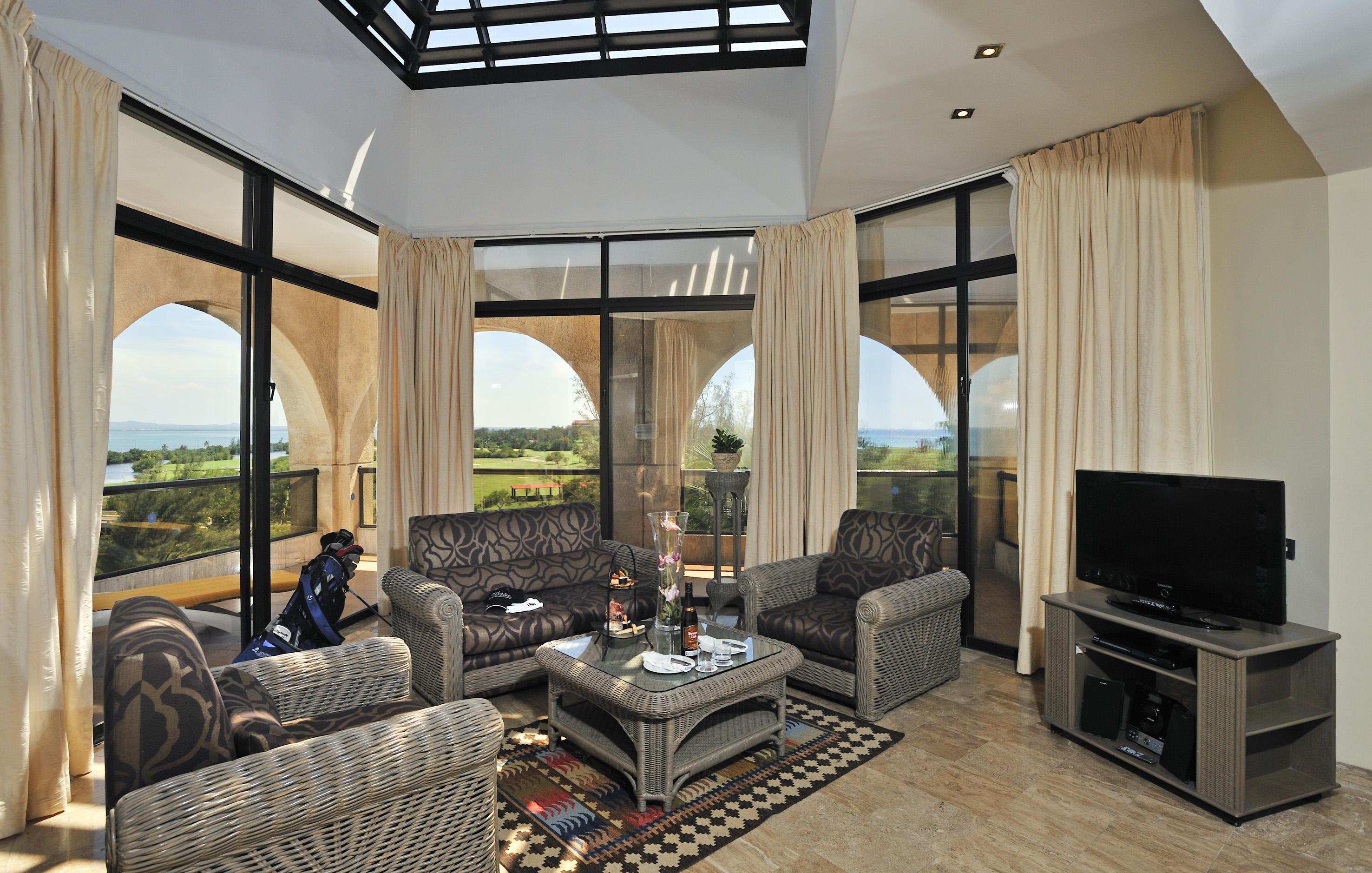 a living room with a glass roof and a television