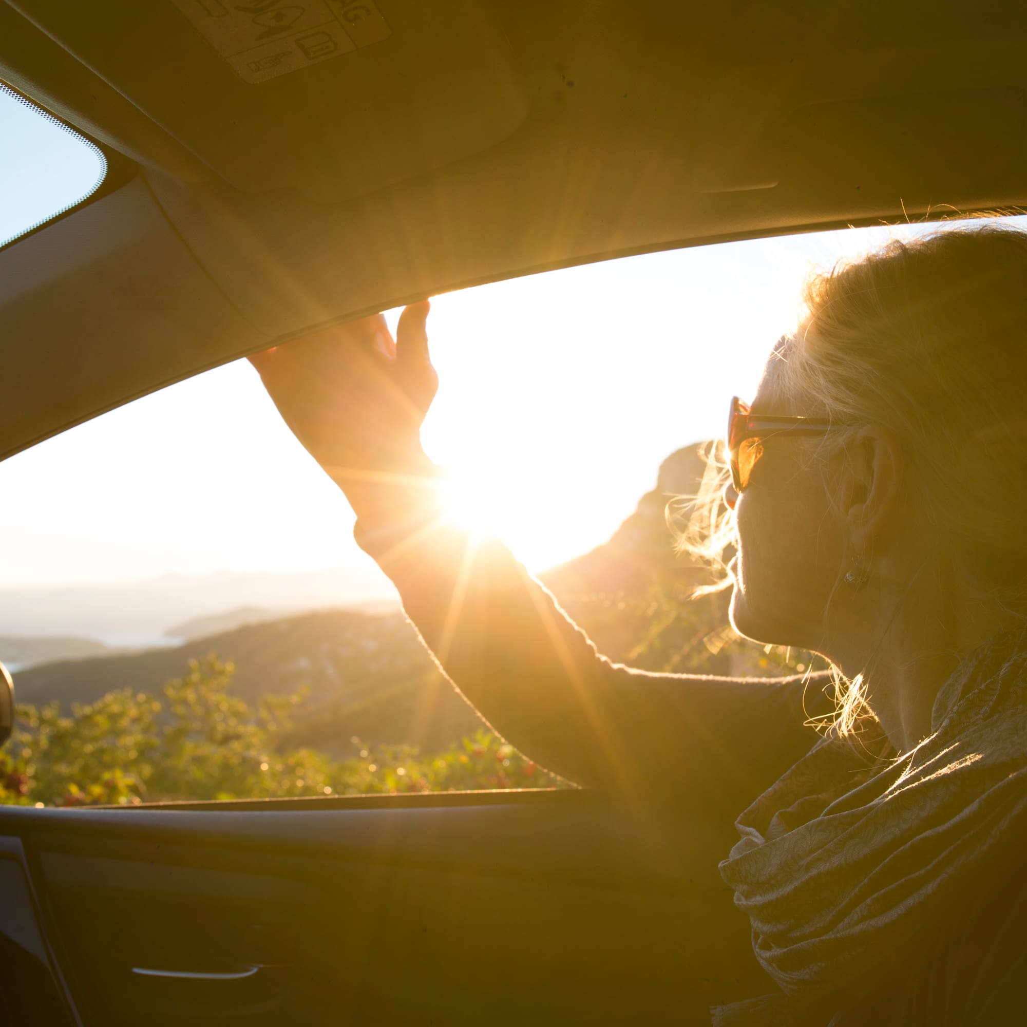 a woman in a car looking out the window