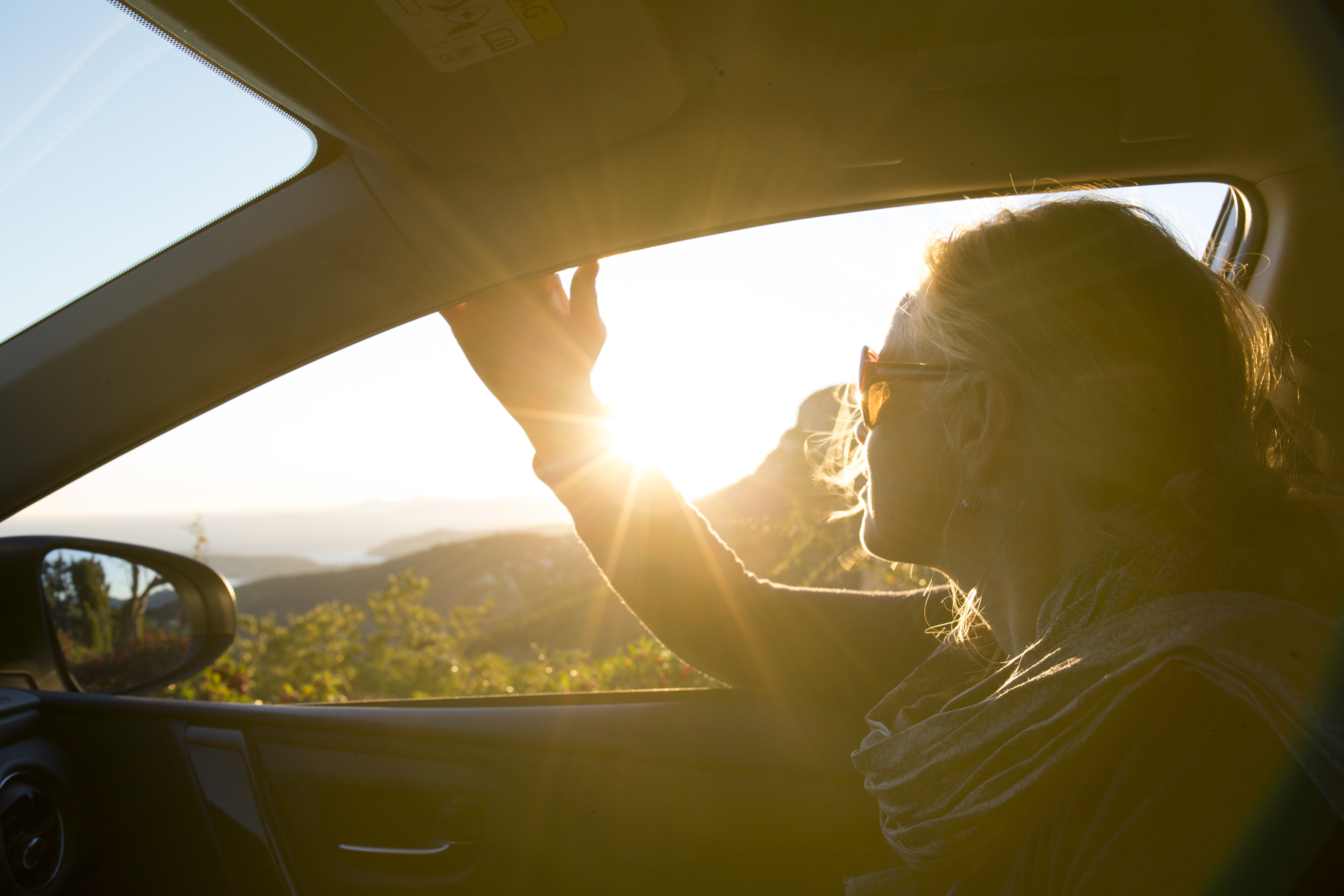a woman in a car looking out the window