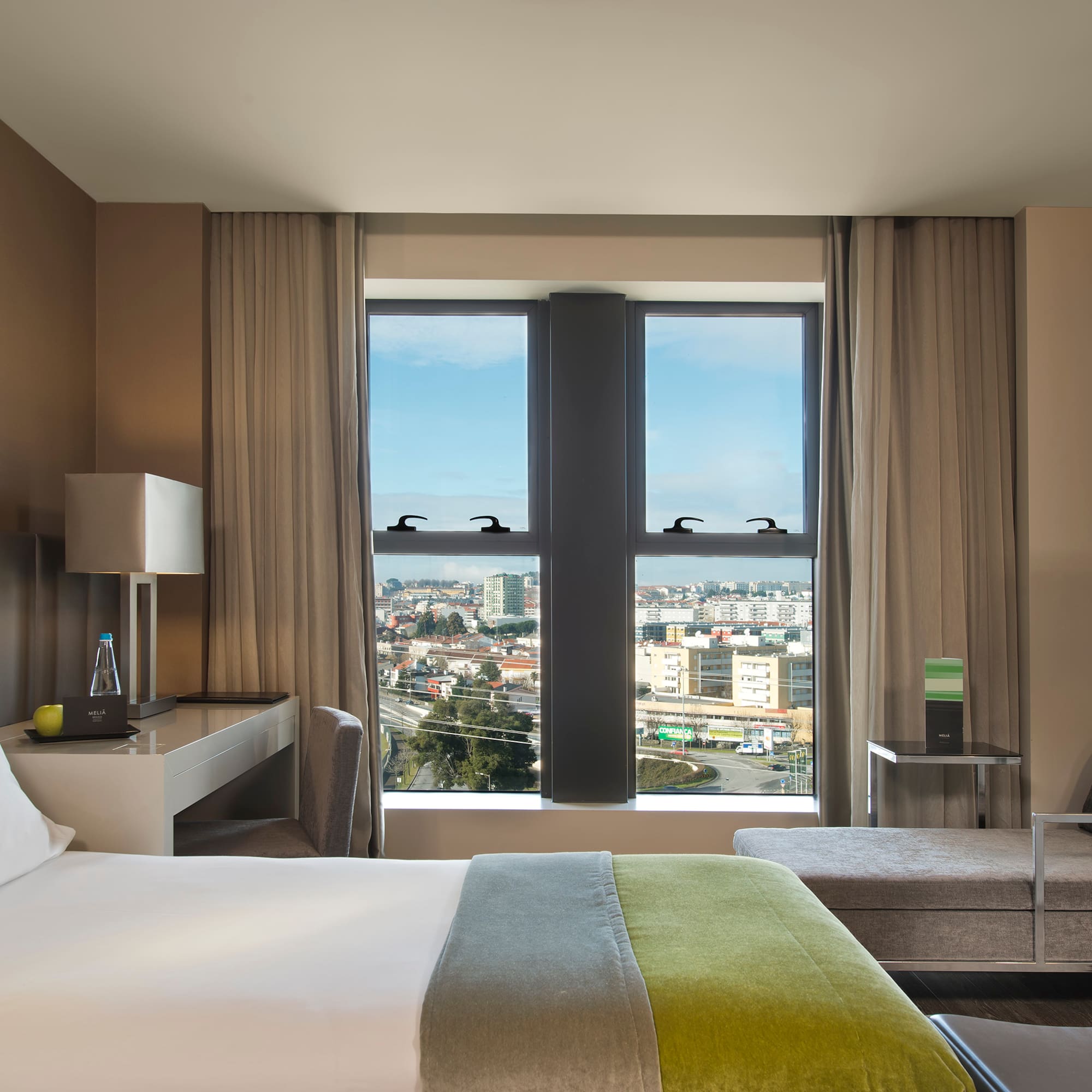 a room with a bed and a table and chairs