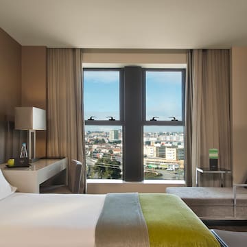 a room with a bed and a table and chairs