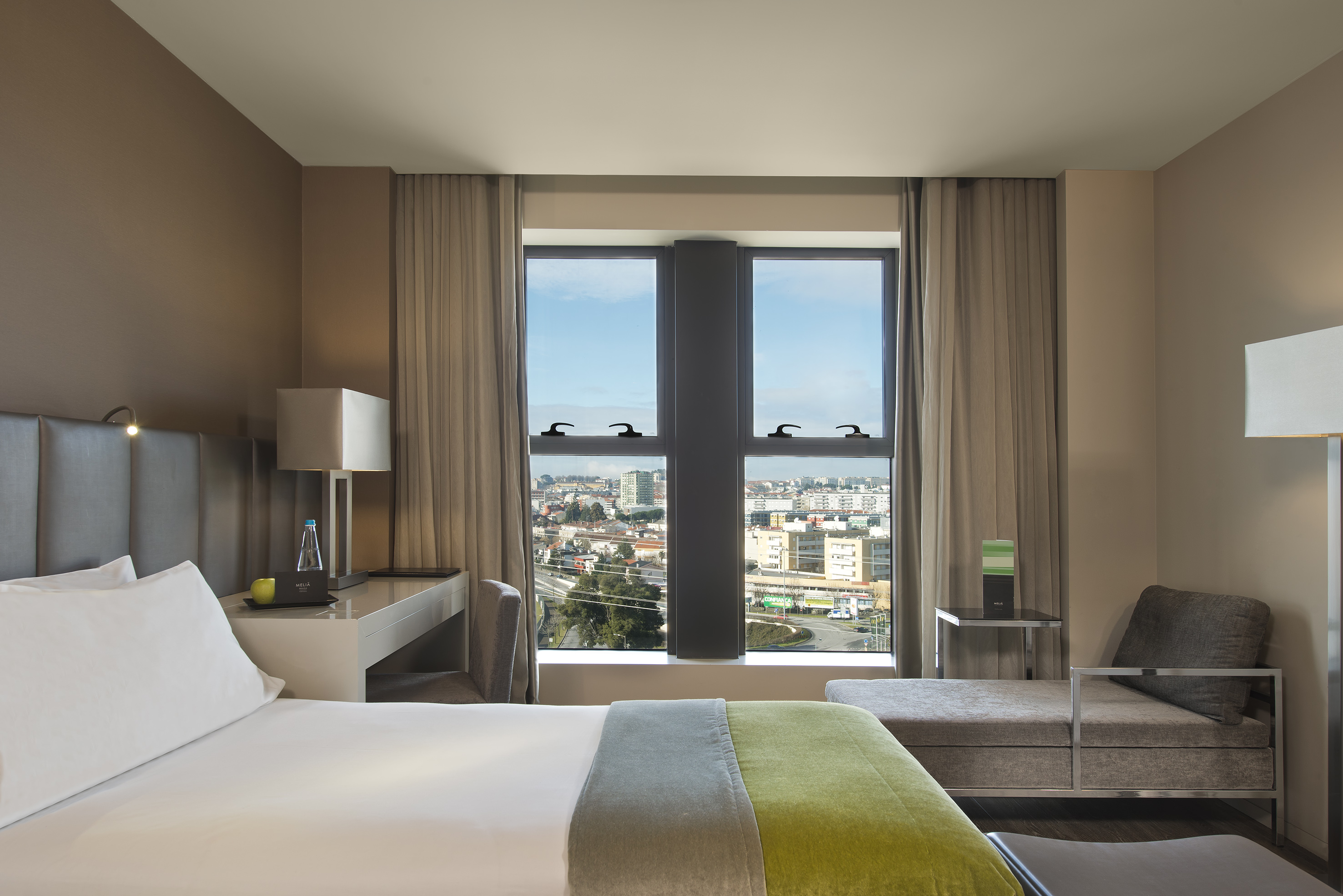 a room with a bed and a table and chairs