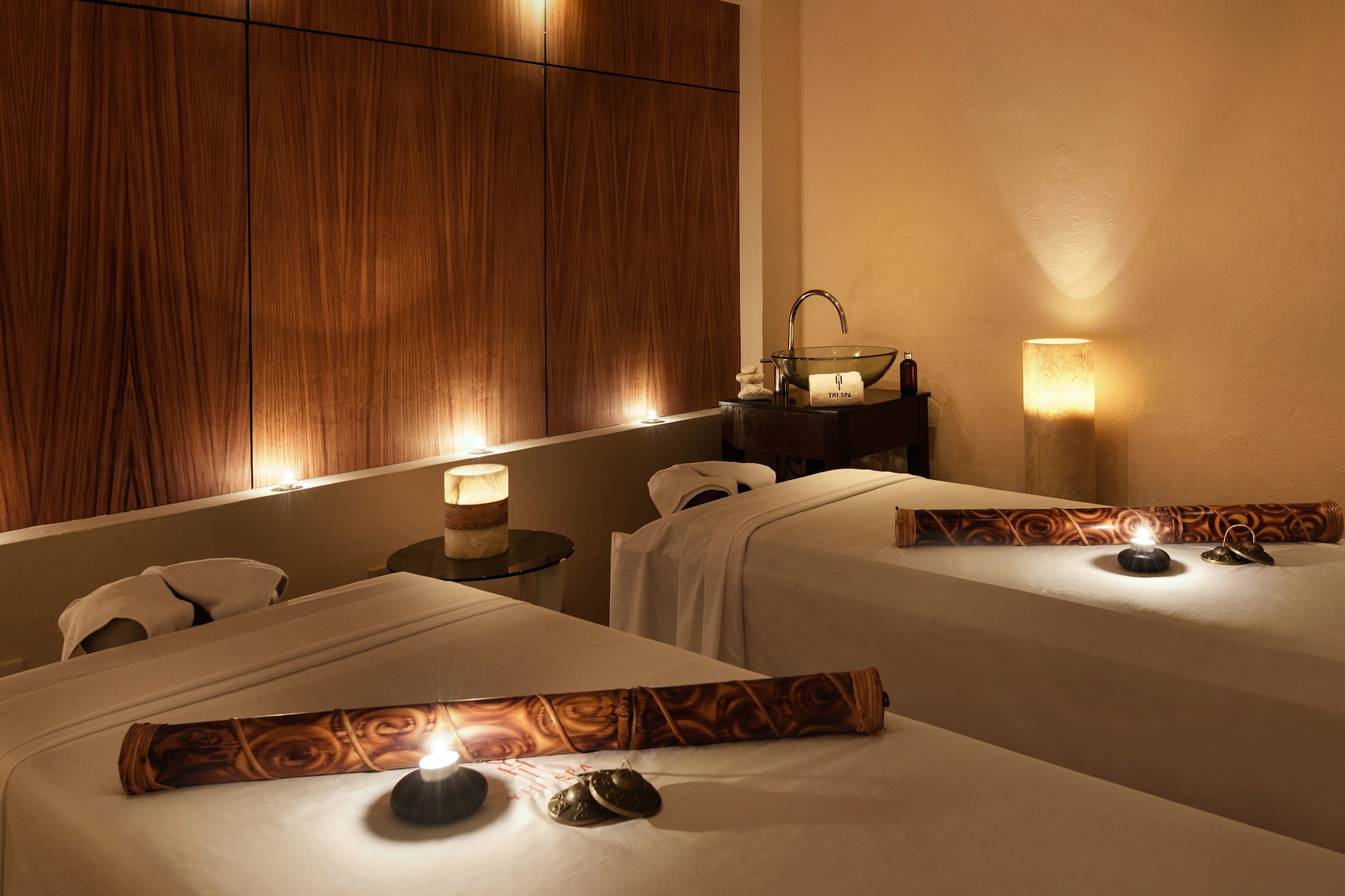 a massage room with candles and massage table