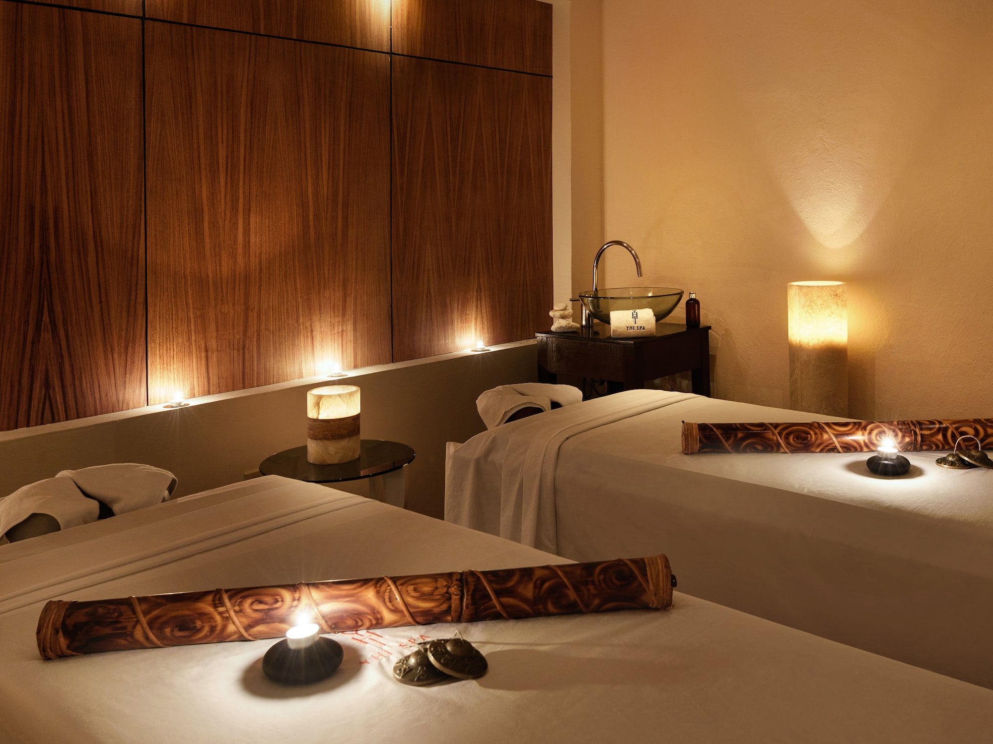 a massage room with candles and massage table