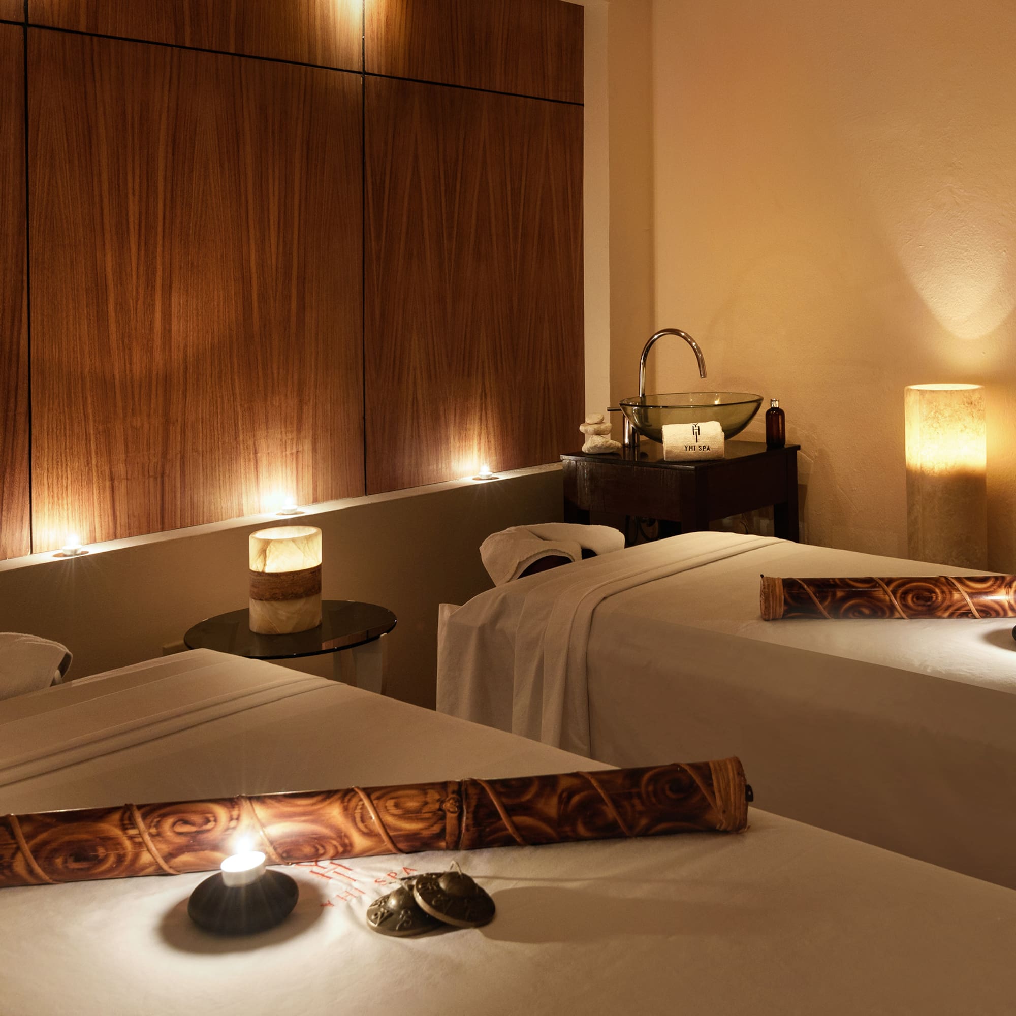 a massage room with candles and massage table