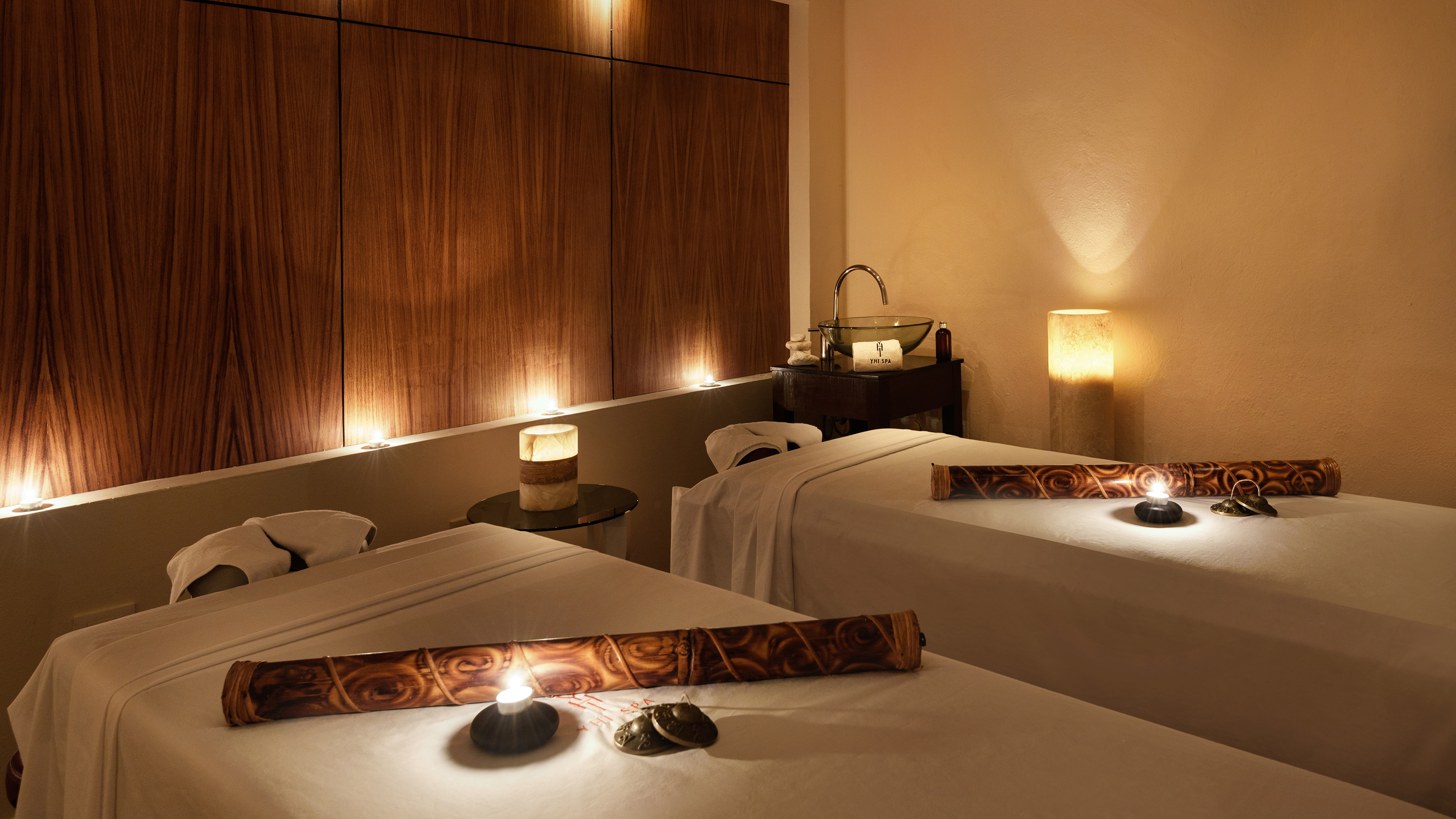 a massage room with candles and massage table