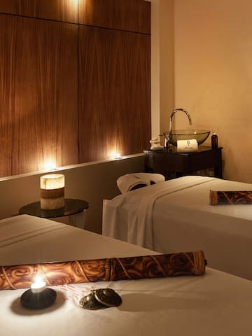 a massage room with candles and massage table