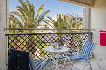 a chair and table on a balcony