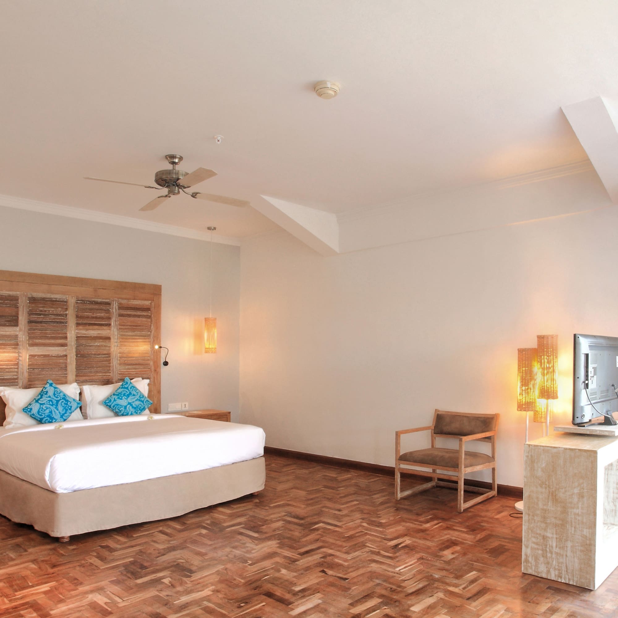 a room with a bed and a television