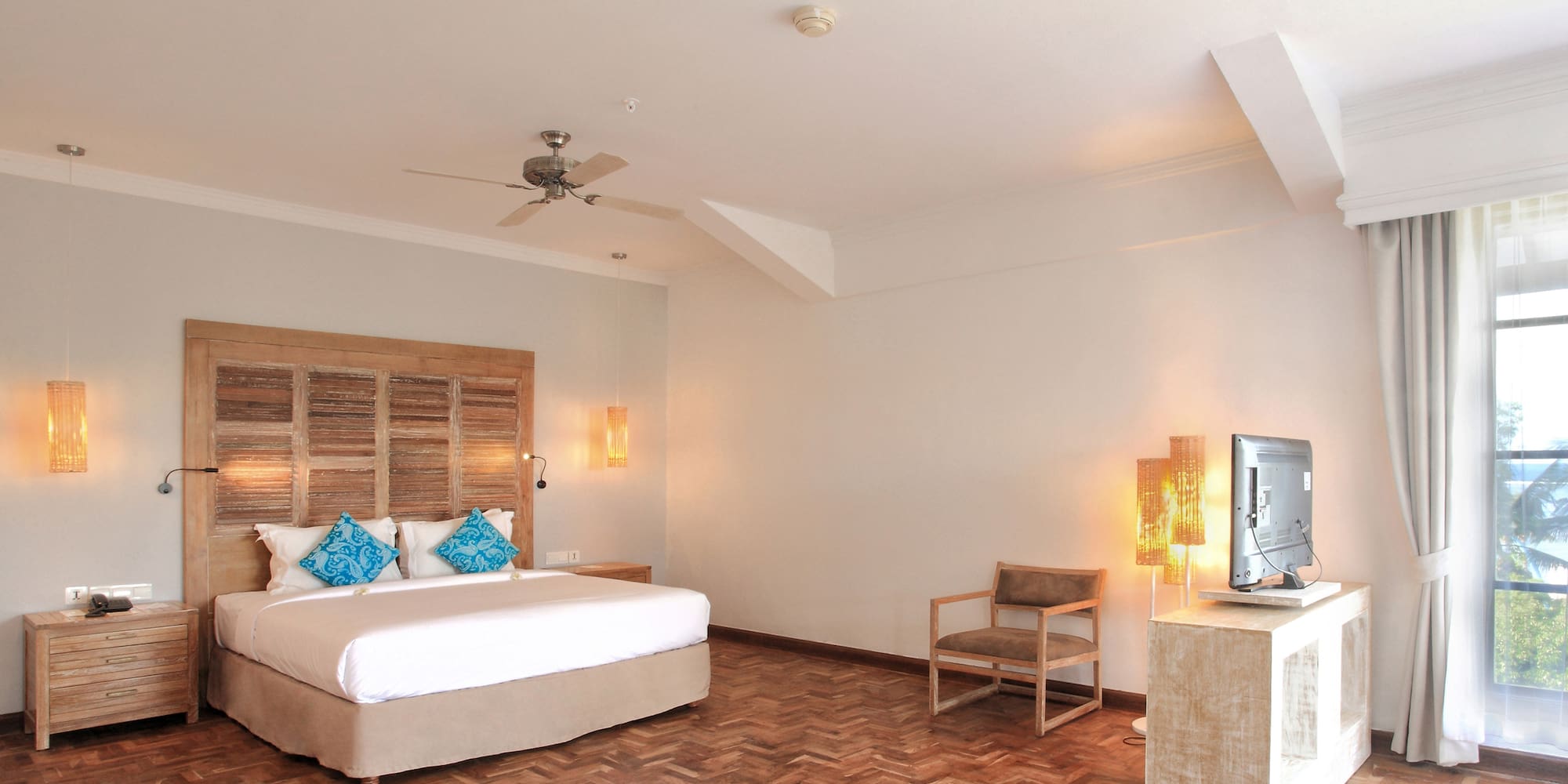 a room with a bed and a television