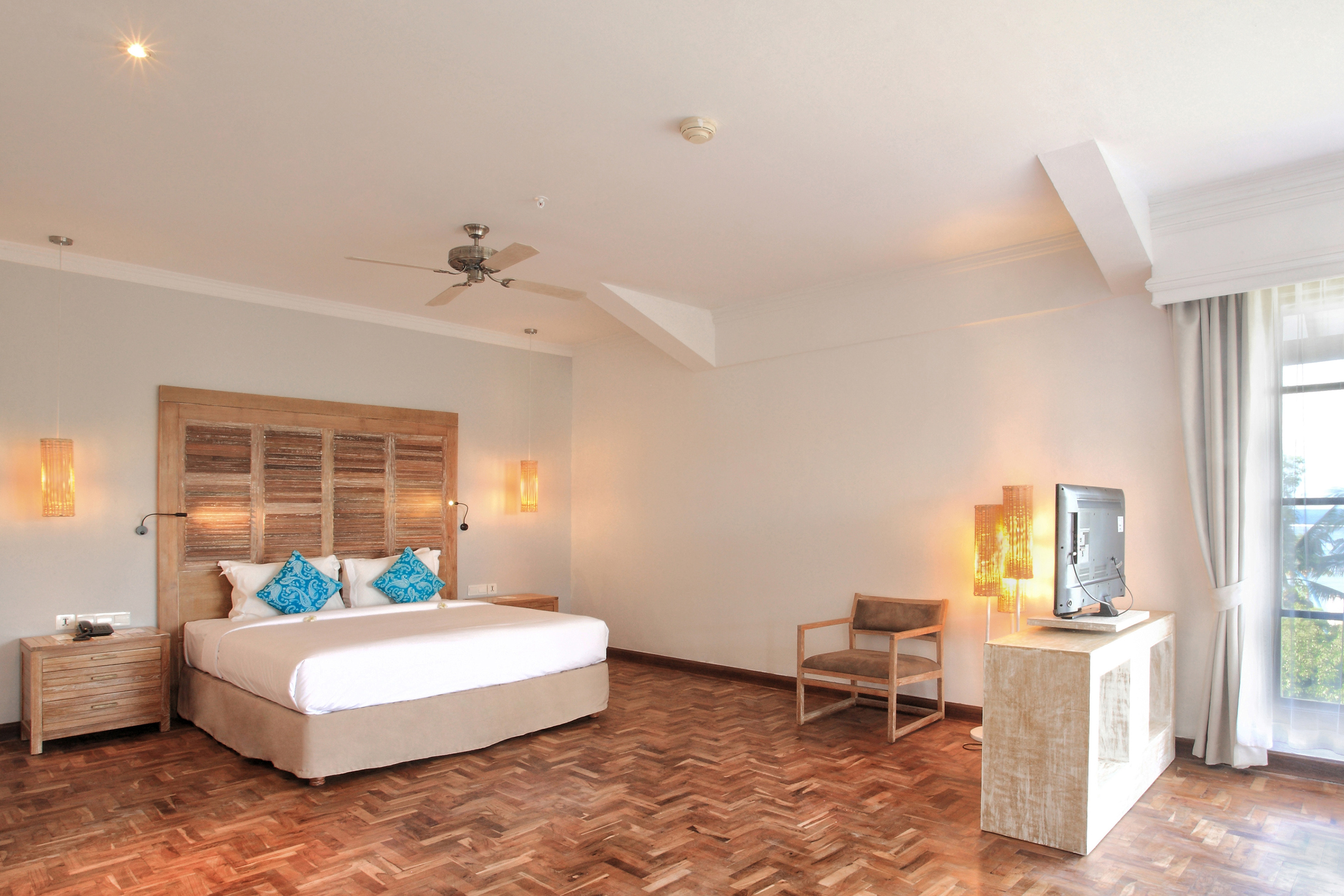 a room with a bed and a television