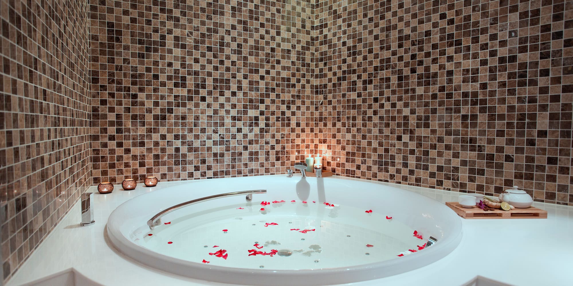 a bathtub with rose petals in it