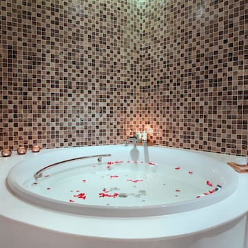 a bathtub with rose petals in it
