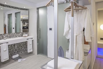 a bathroom with a shower and a towel rack
