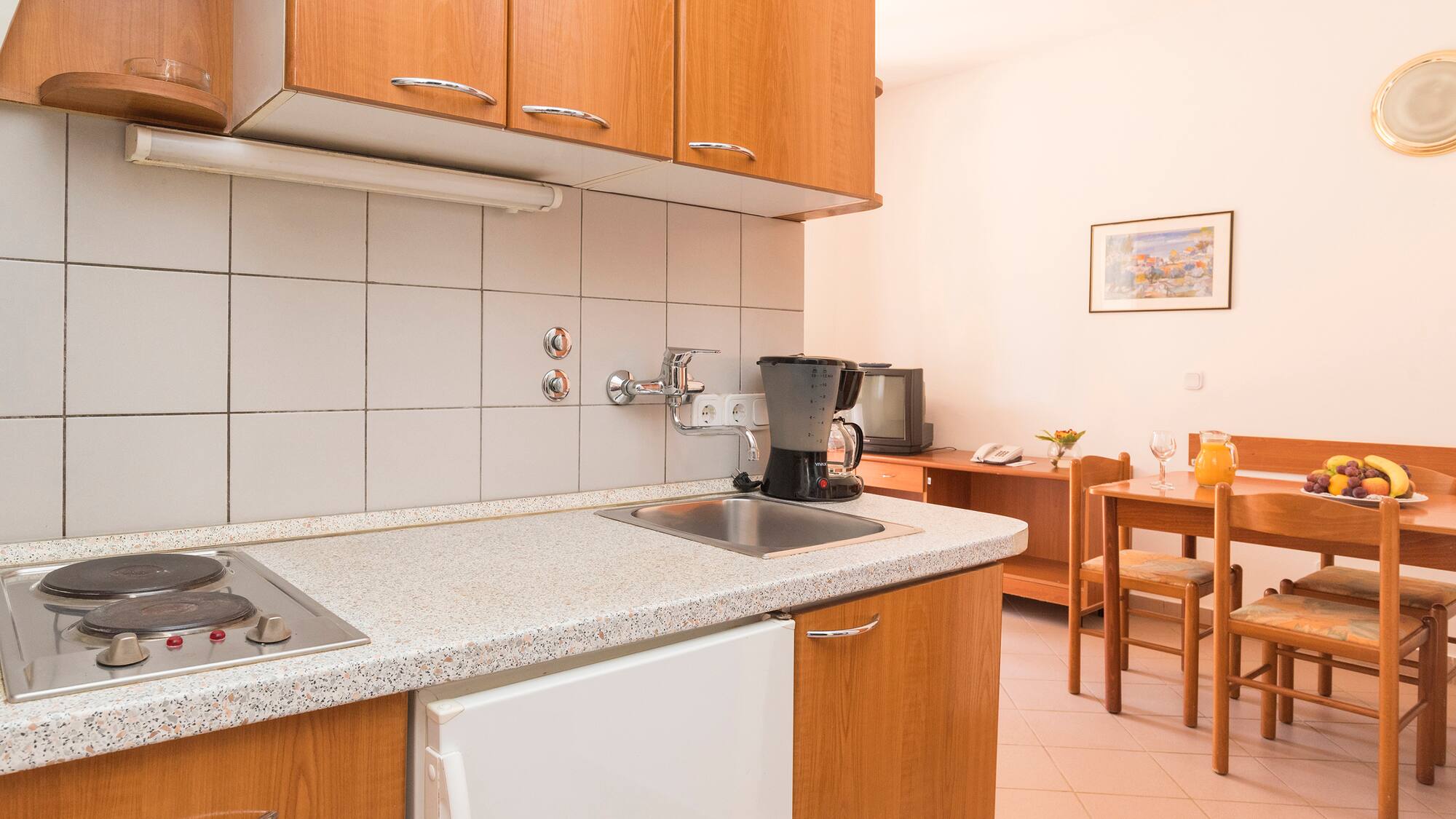 a kitchen with a table and chairs
