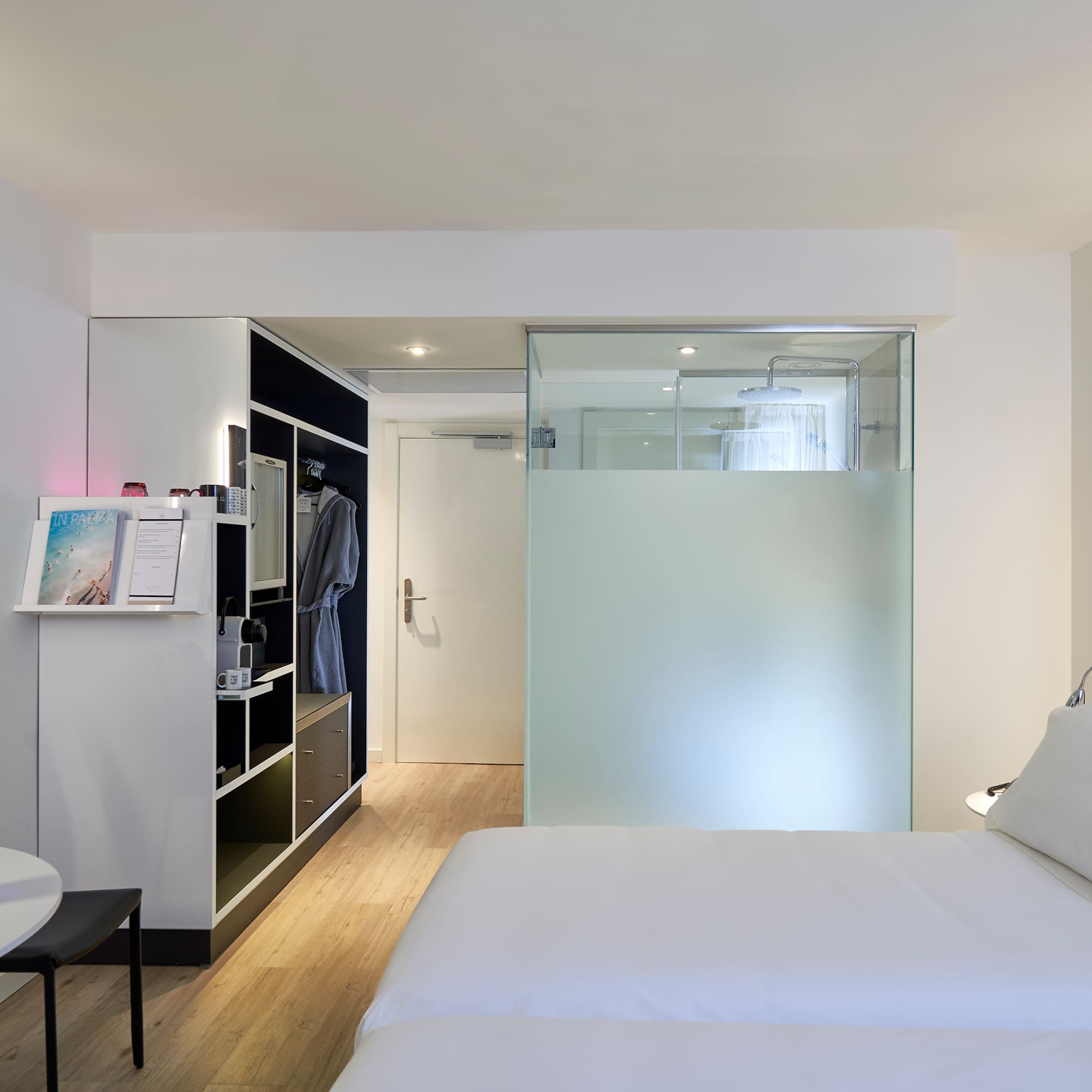 a room with a bed and a glass partition