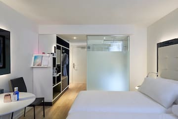 a room with a bed and a glass partition