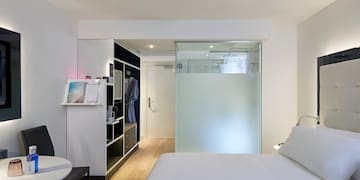a room with a bed and a glass partition