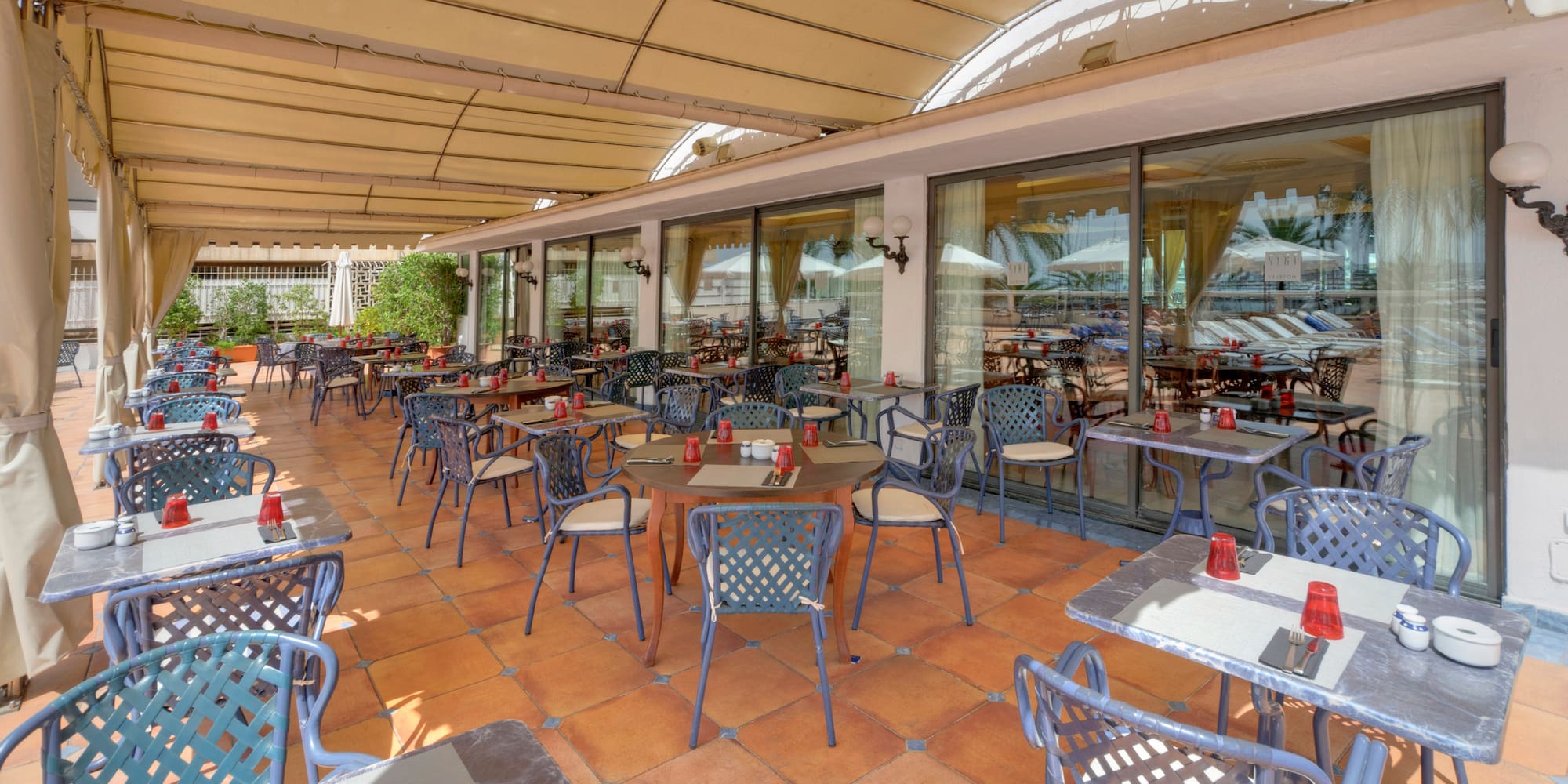 a patio with tables and chairs