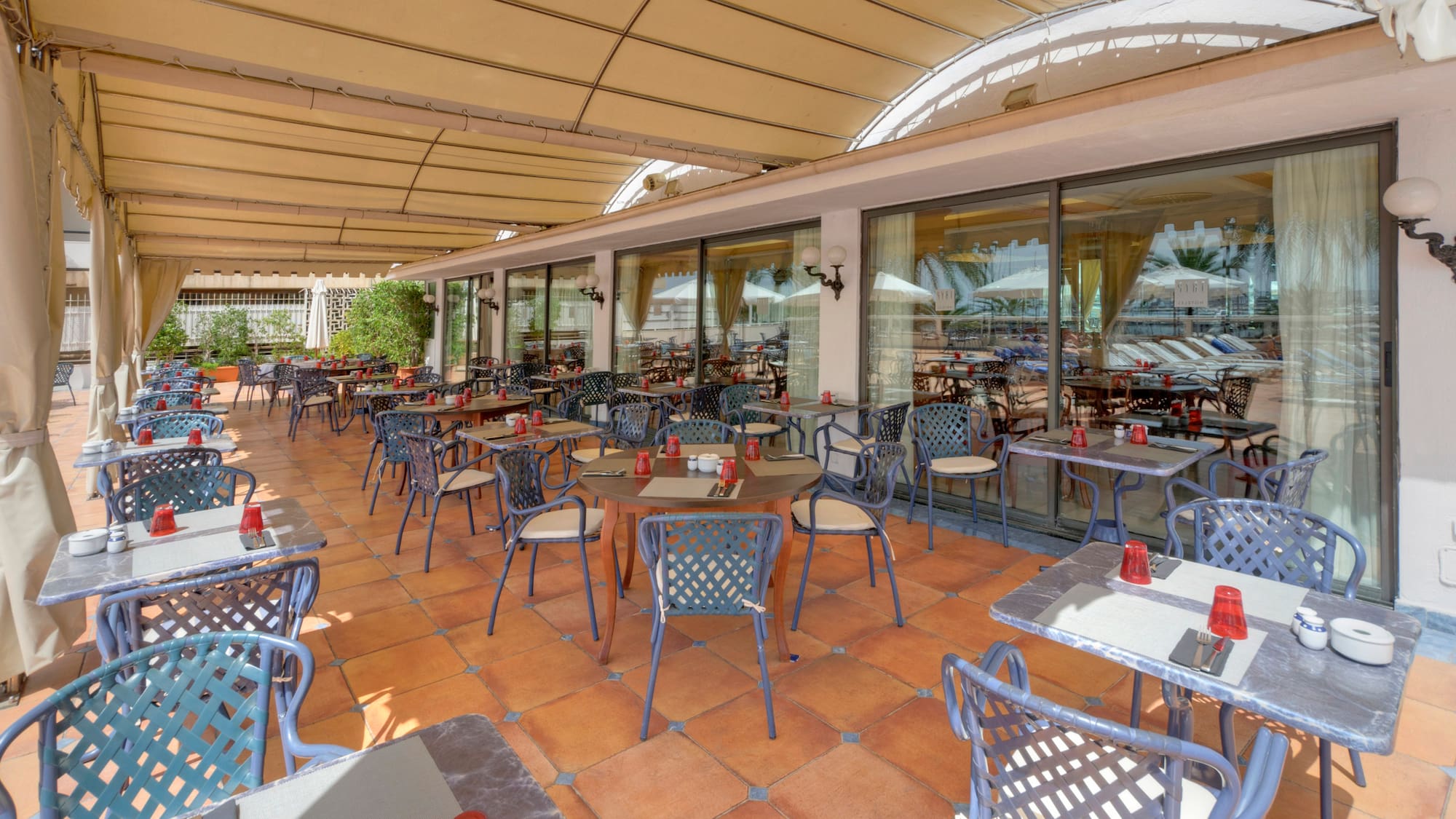 a patio with tables and chairs