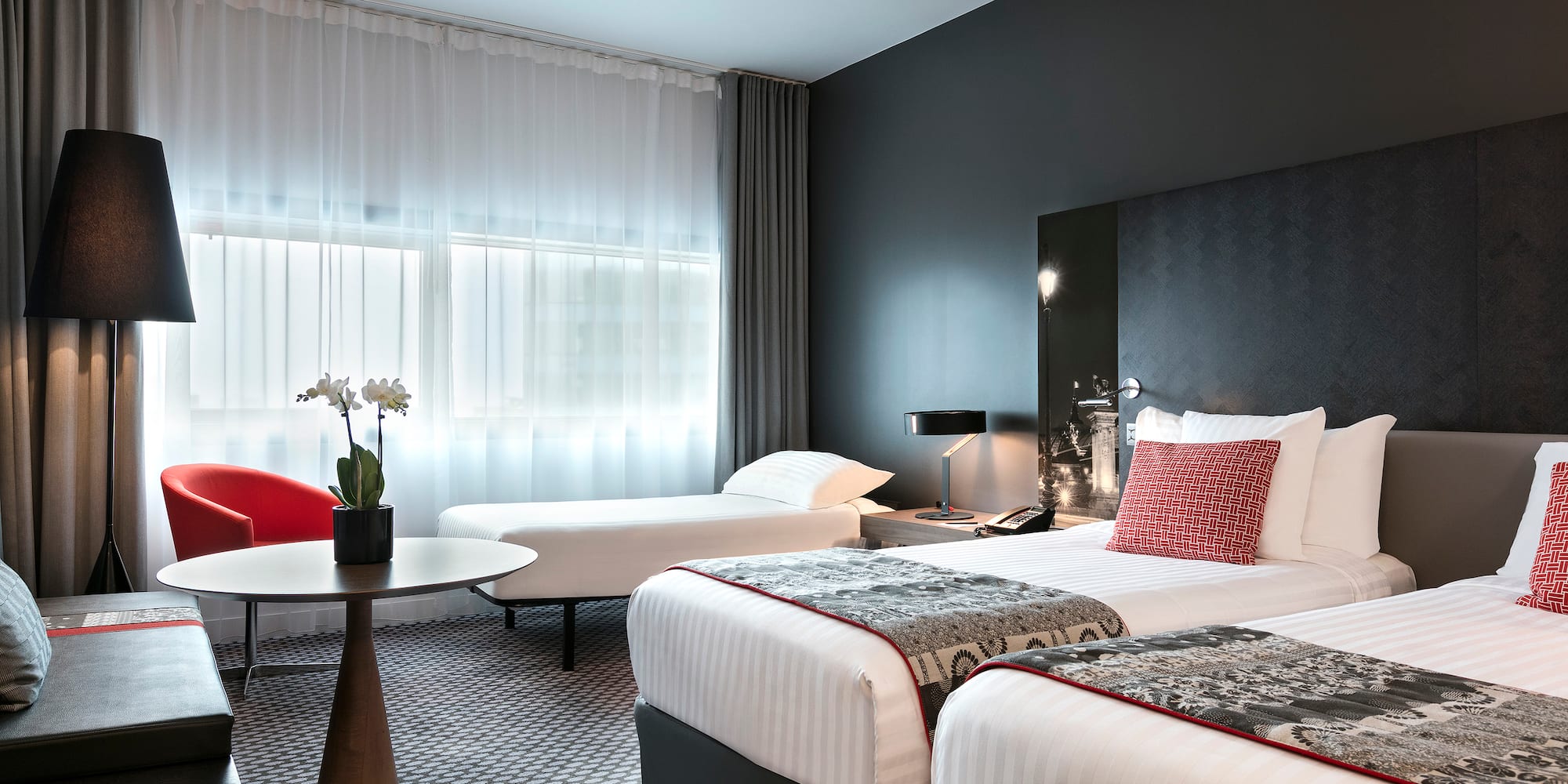 a room with two beds and a table