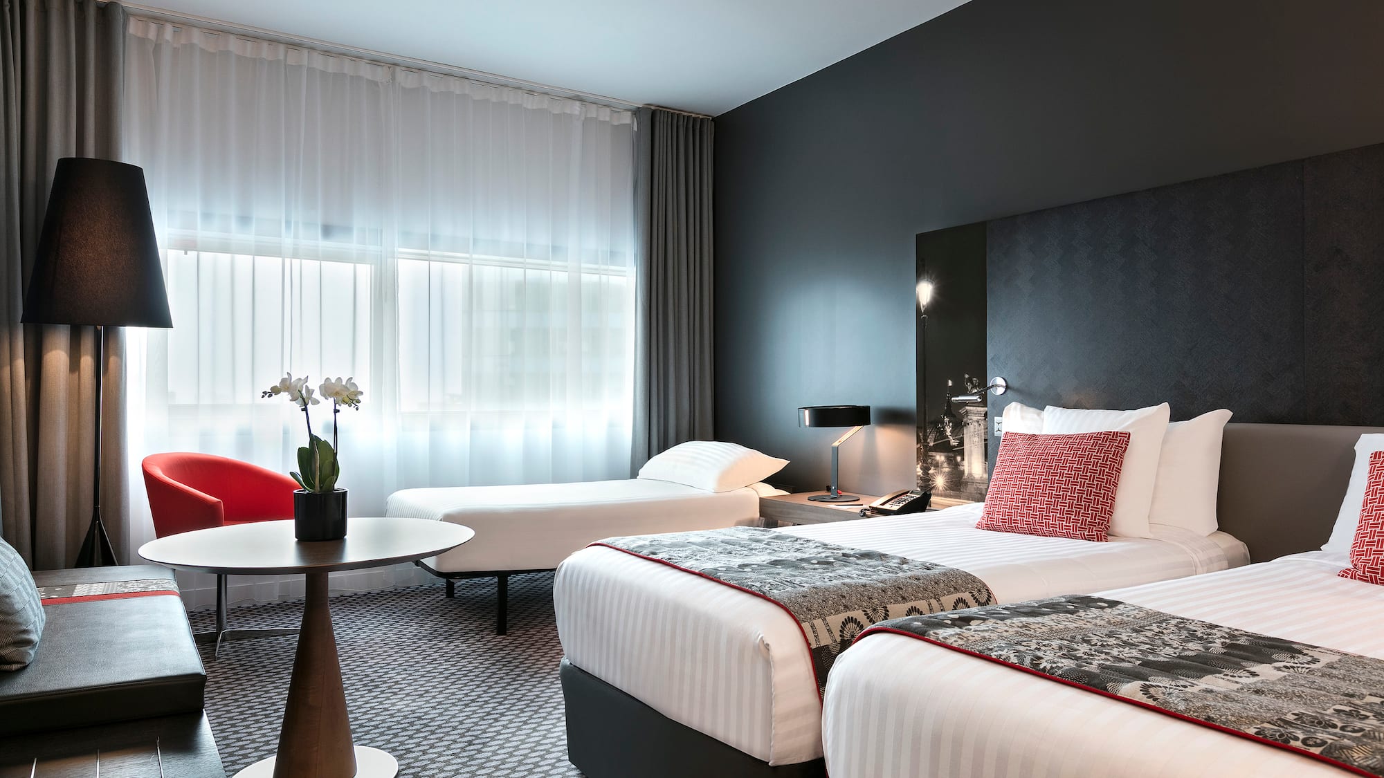 a room with two beds and a table