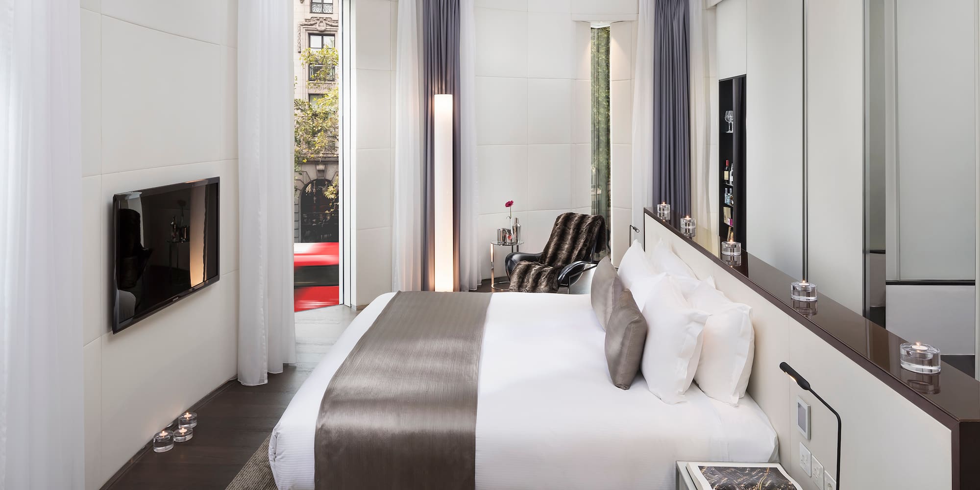 a bedroom with a bed and a tv