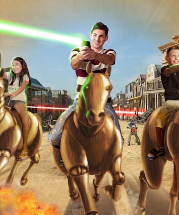 a group of people riding horses with laser beams