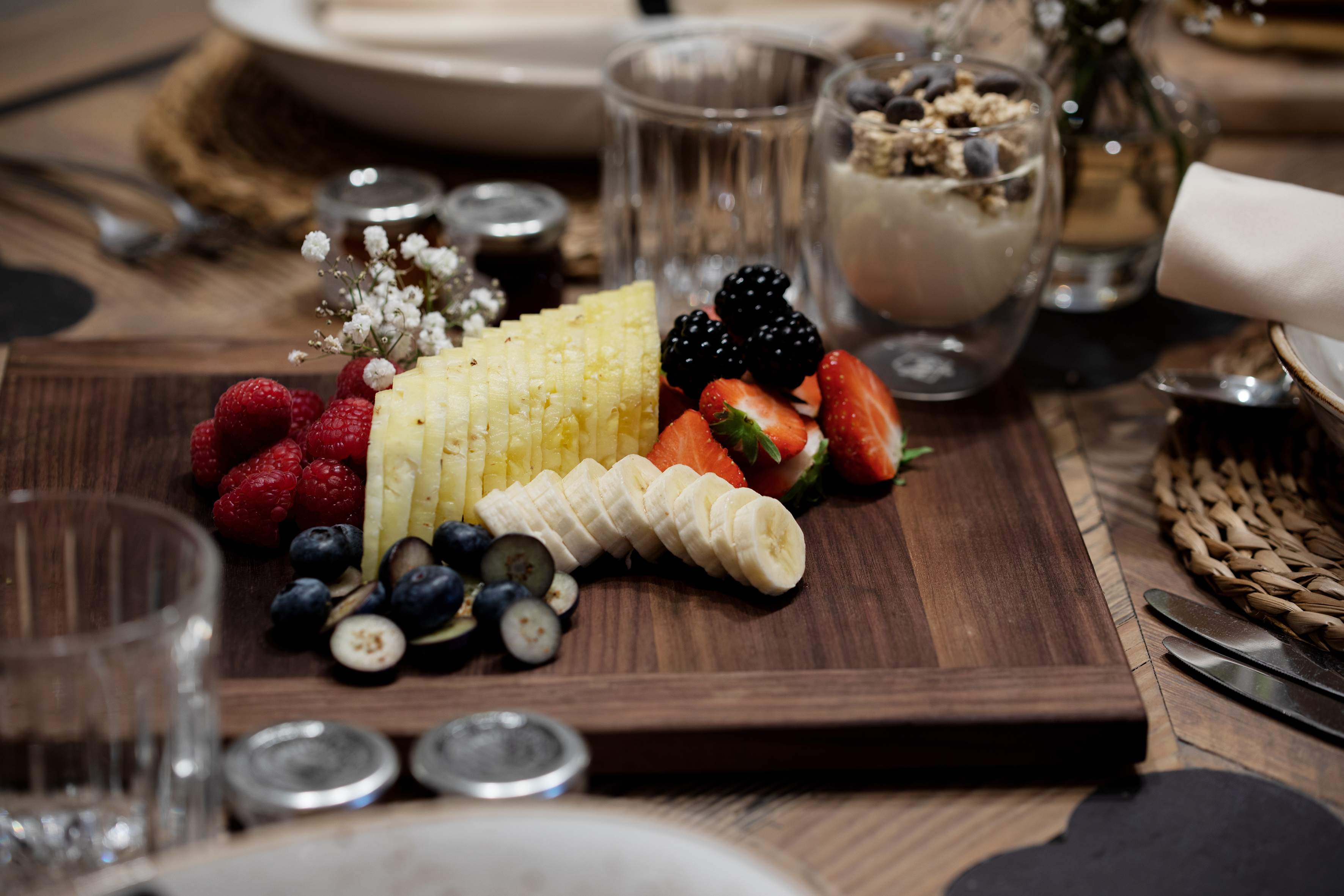 Fresh fruit and yogurt parfait breakfast board.
