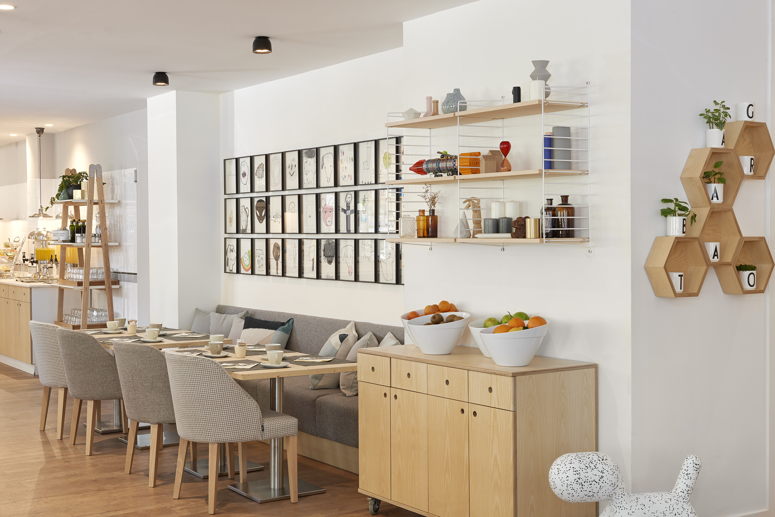 Bright modern breakfast room with buffet, dining tables, and stylish decor.
