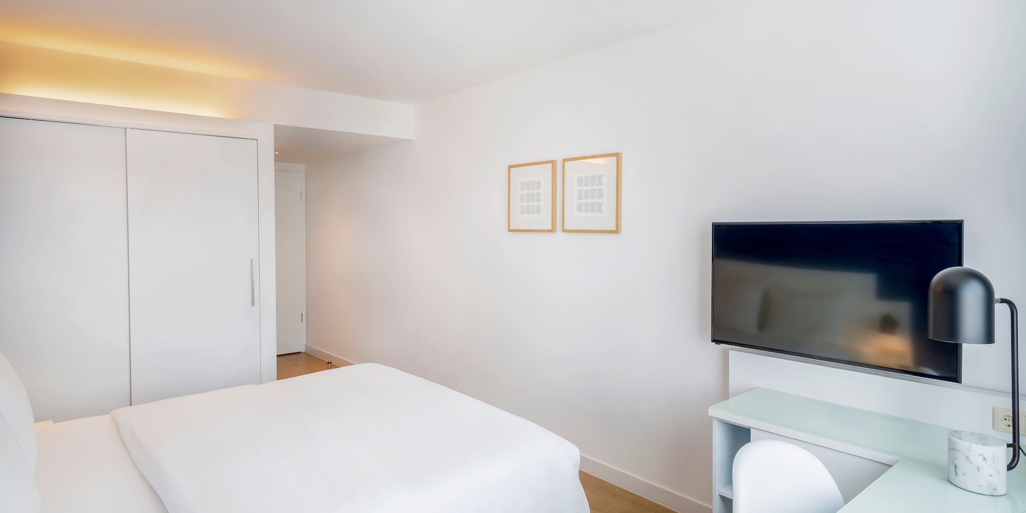 a room with a bed and a tv