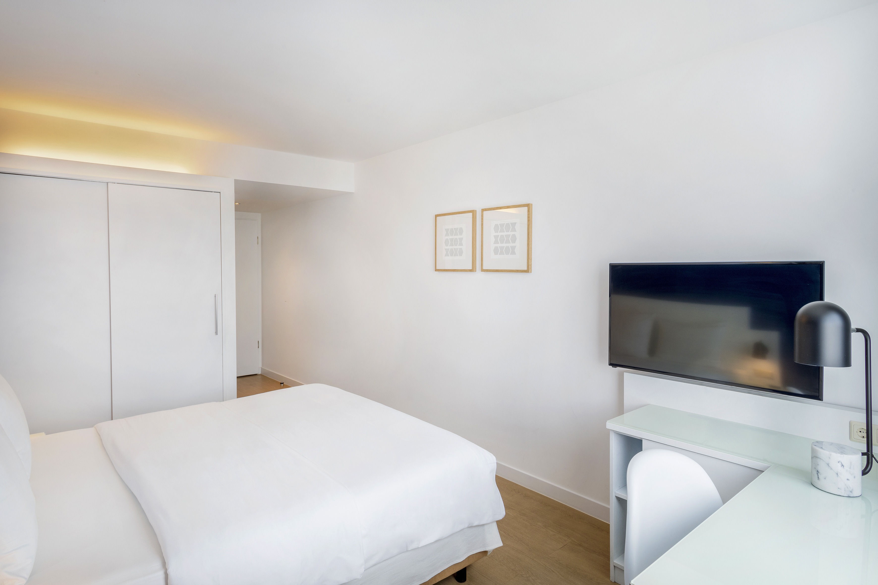 a room with a bed and a tv