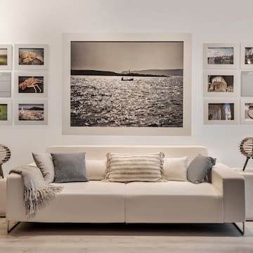 a couch with pillows and a picture on the wall