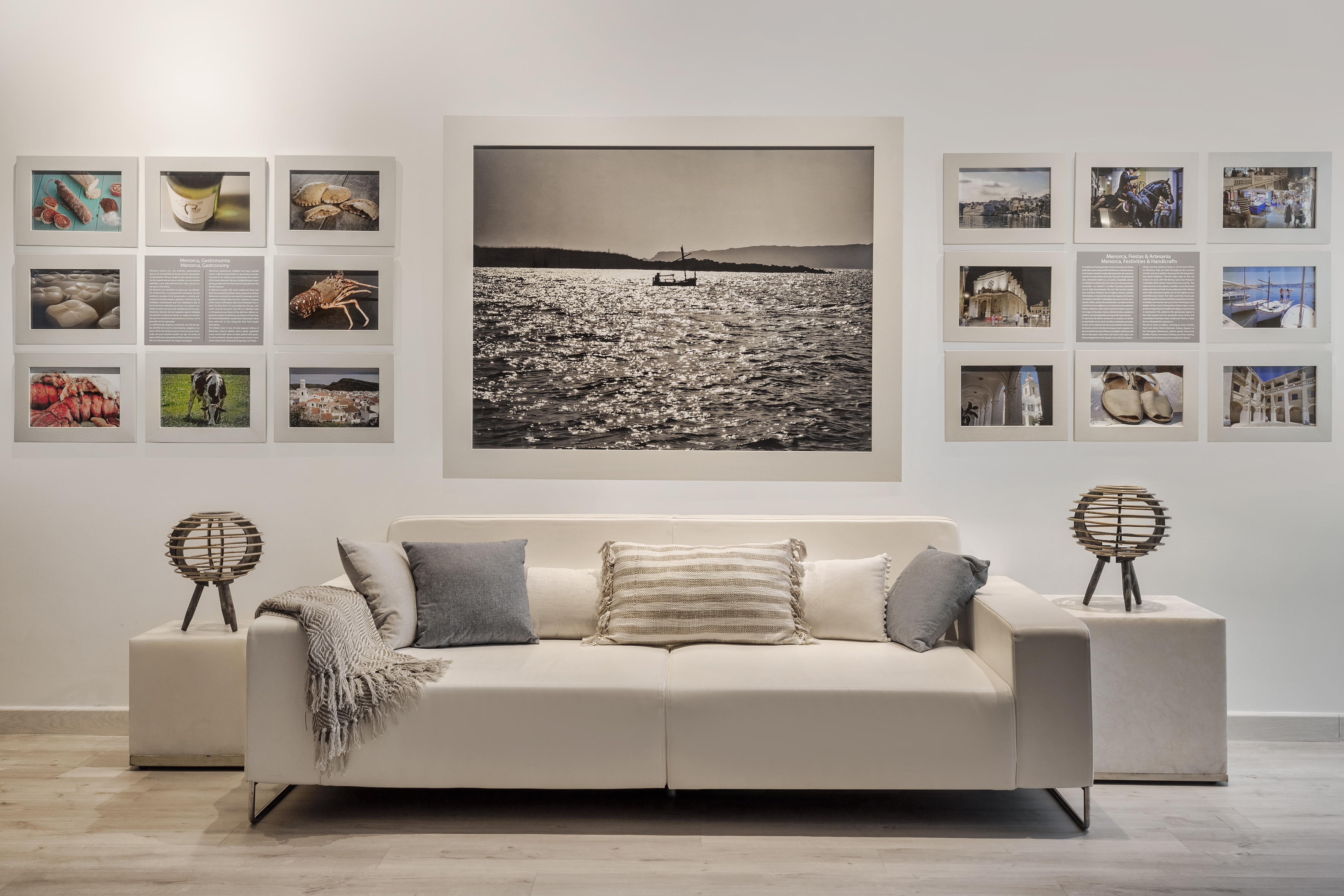 Modern gallery with white sofa, lamps, and Menorca sea, food, culture photos.