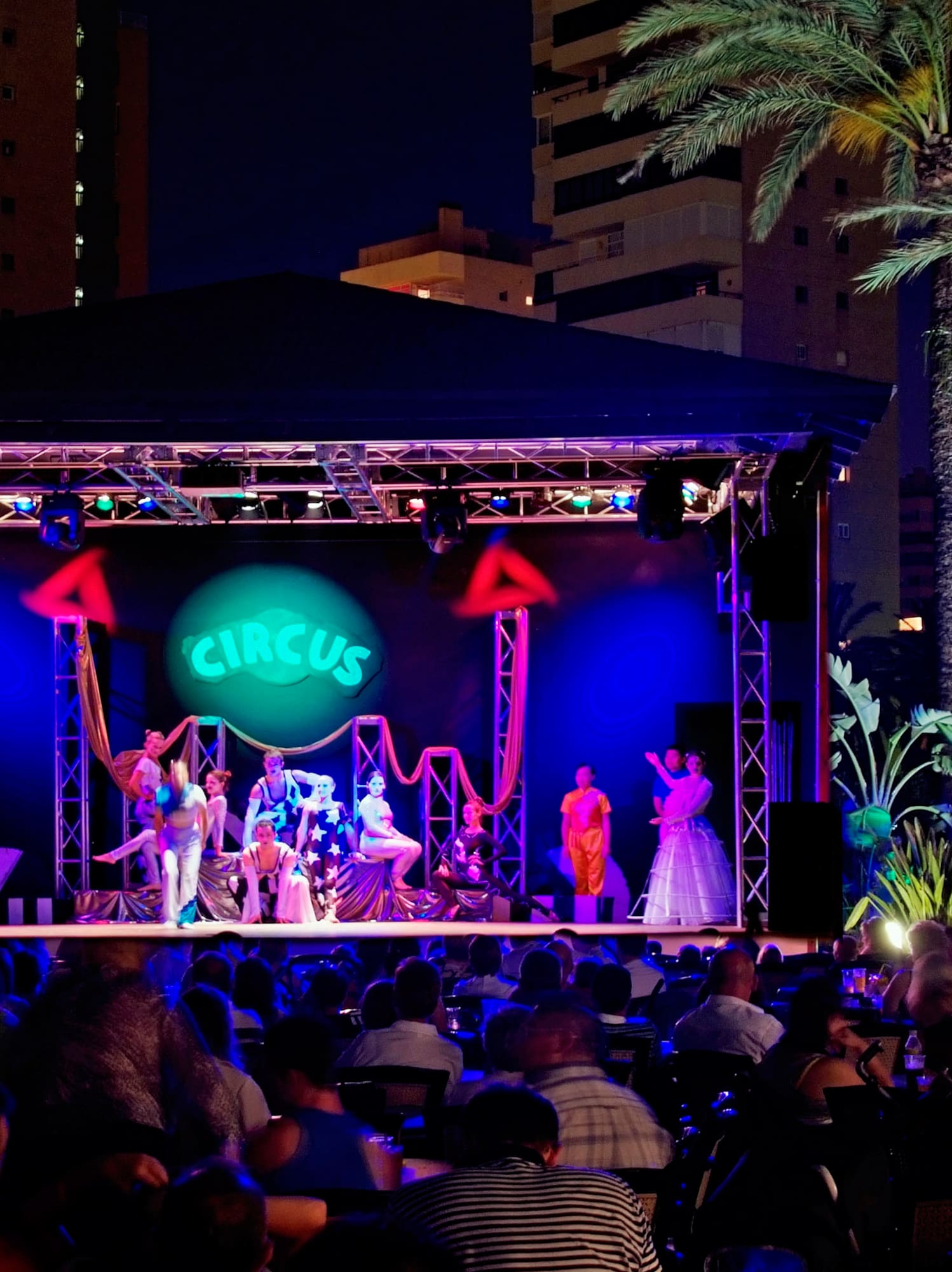 a group of people on a stage with a crowd of people watching