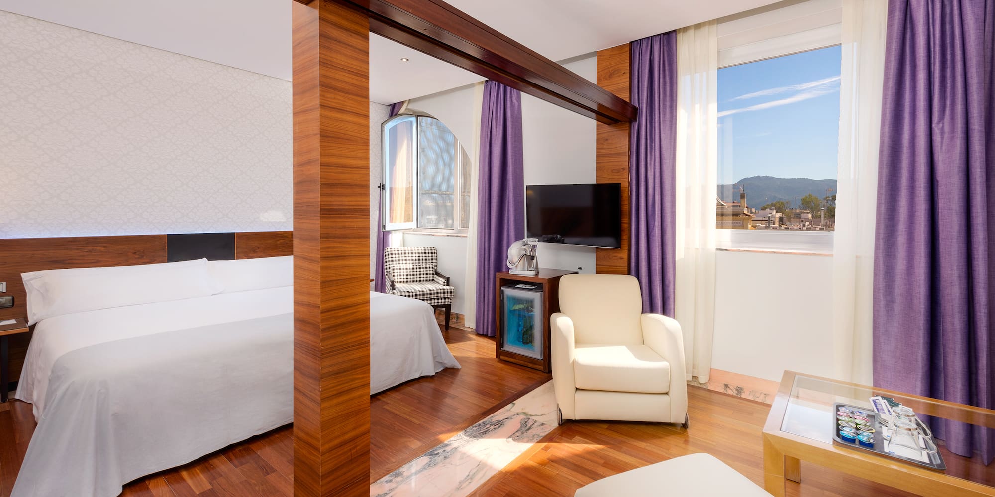 a room with a bed and a television