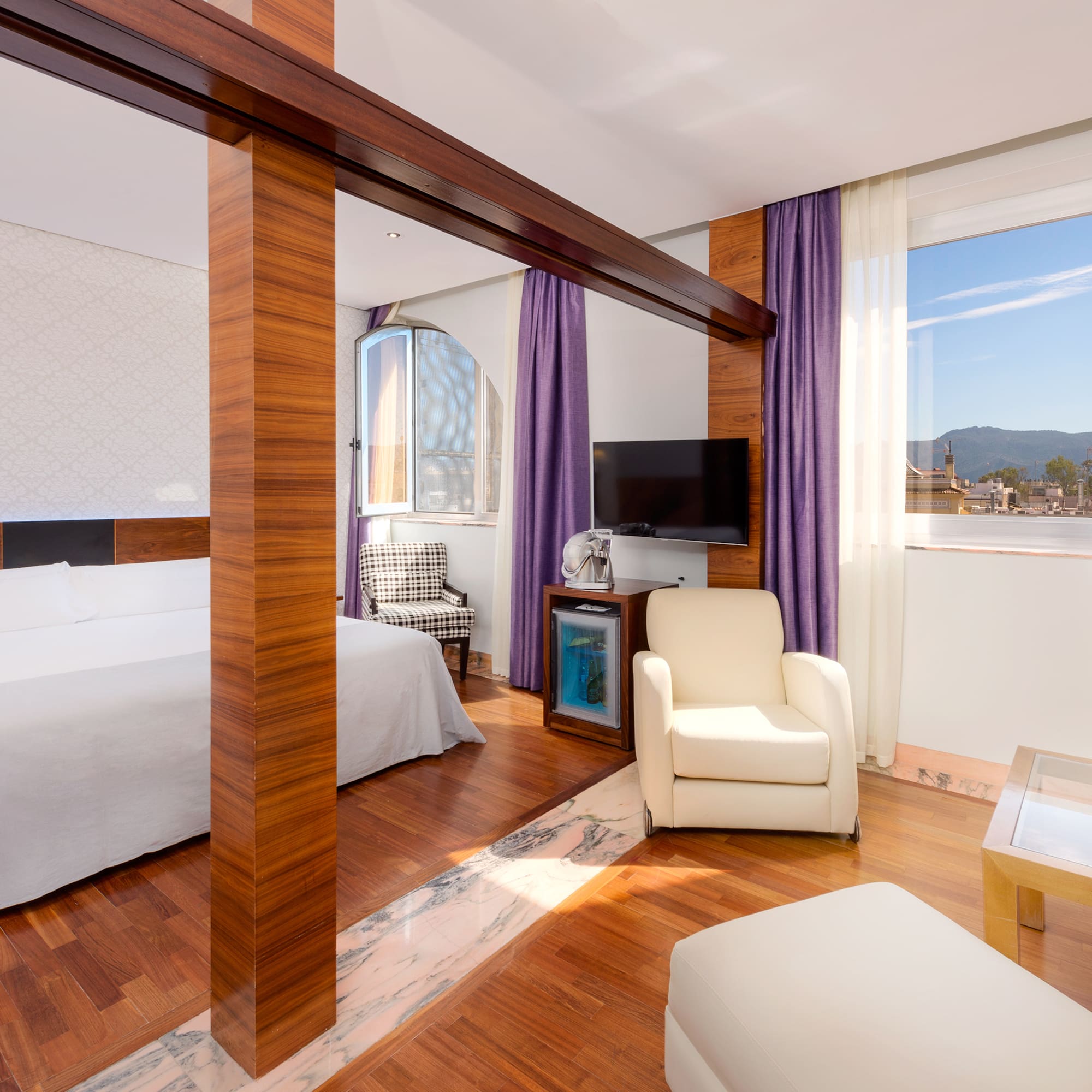 a room with a bed and a television