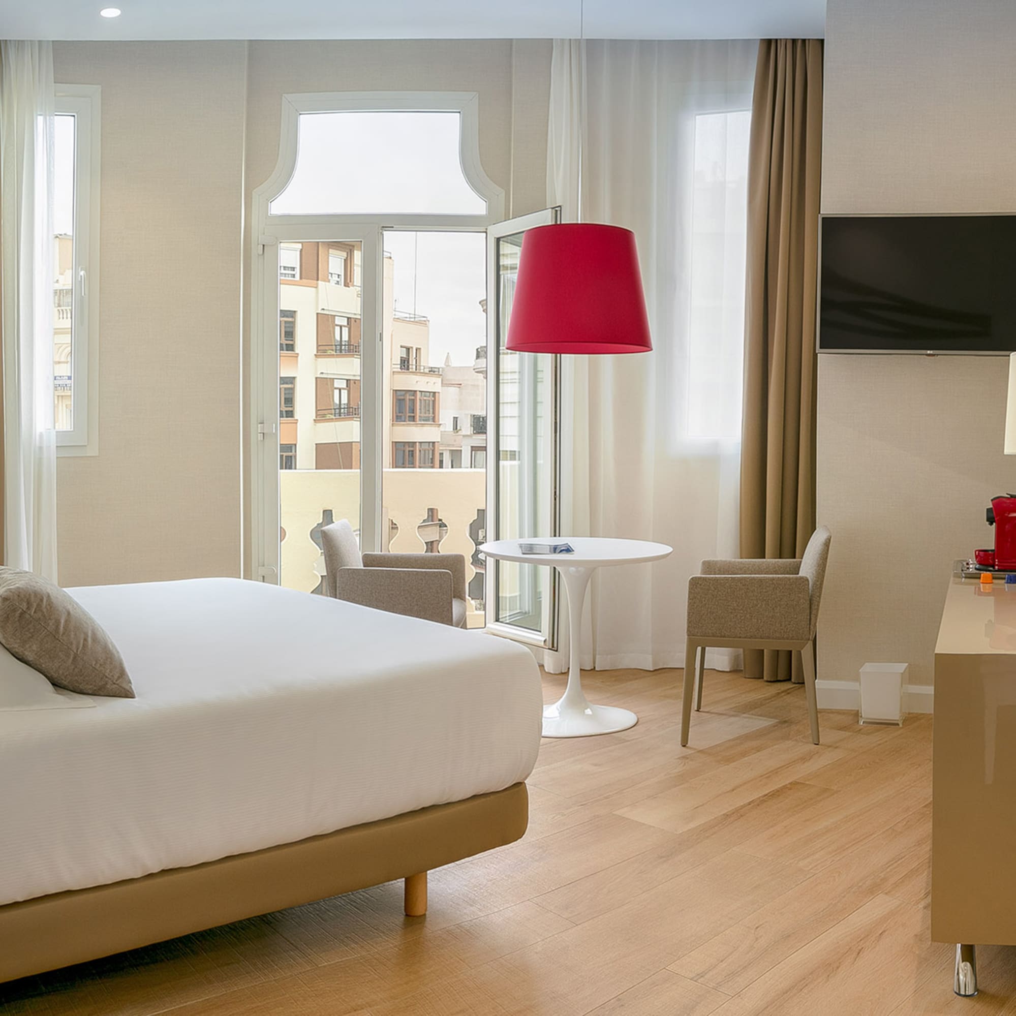 a room with a bed and a table and chairs