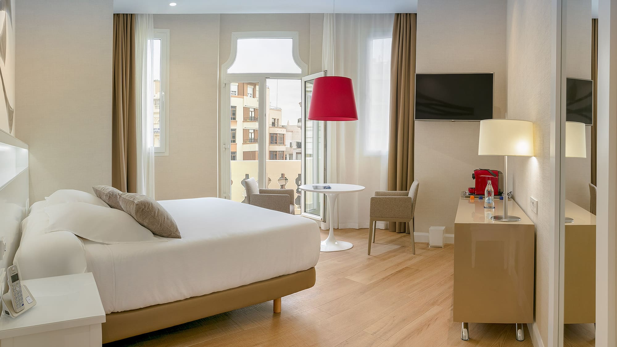 a room with a bed and a table and chairs