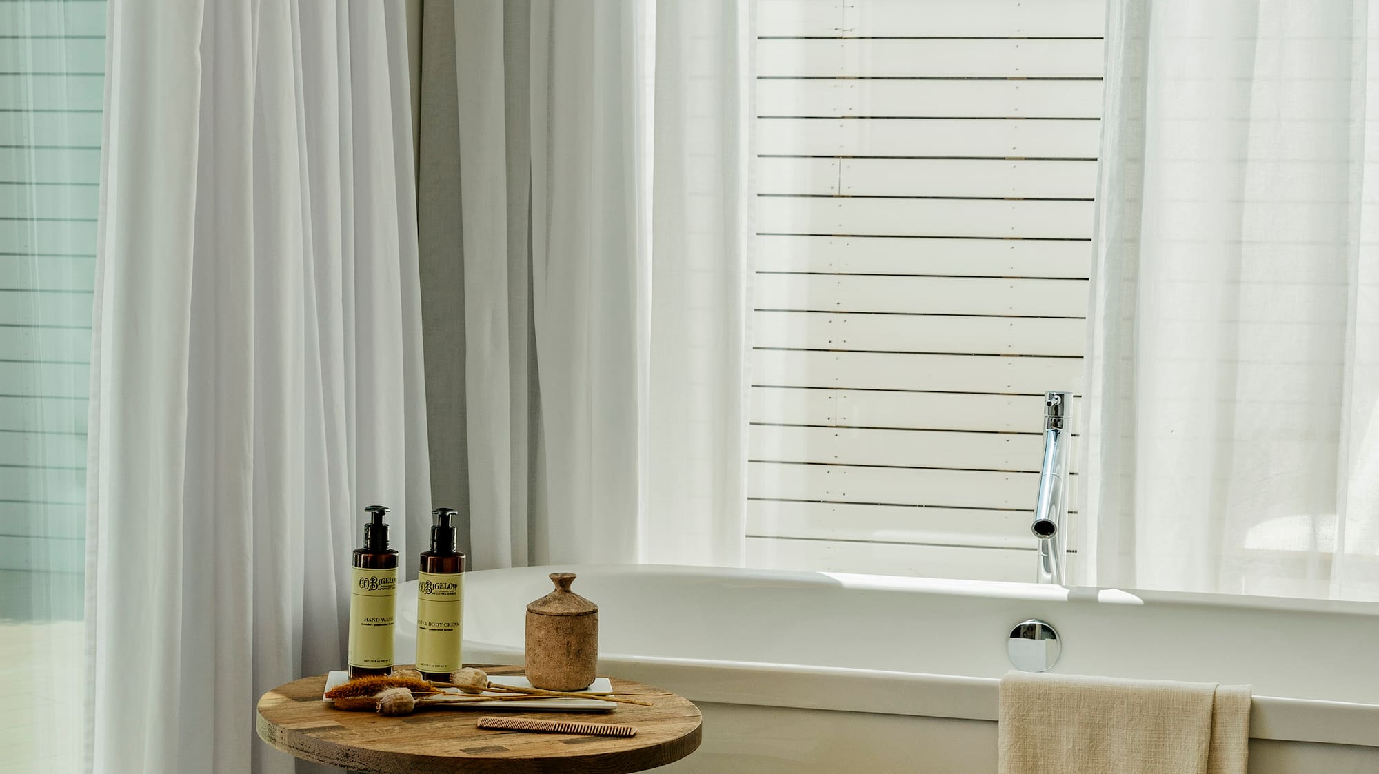 a bathroom with a tub and a table