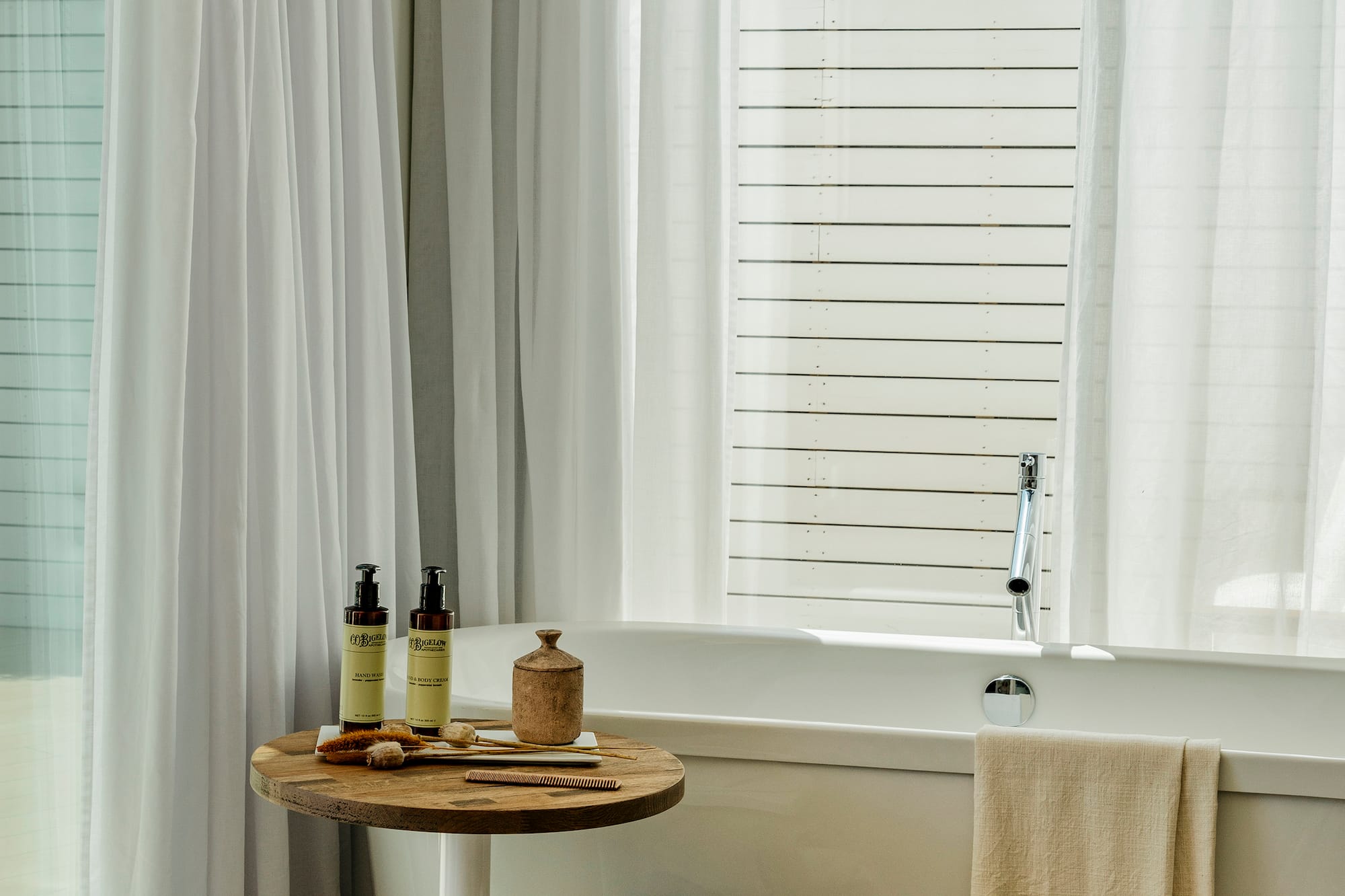 a bathroom with a tub and a table