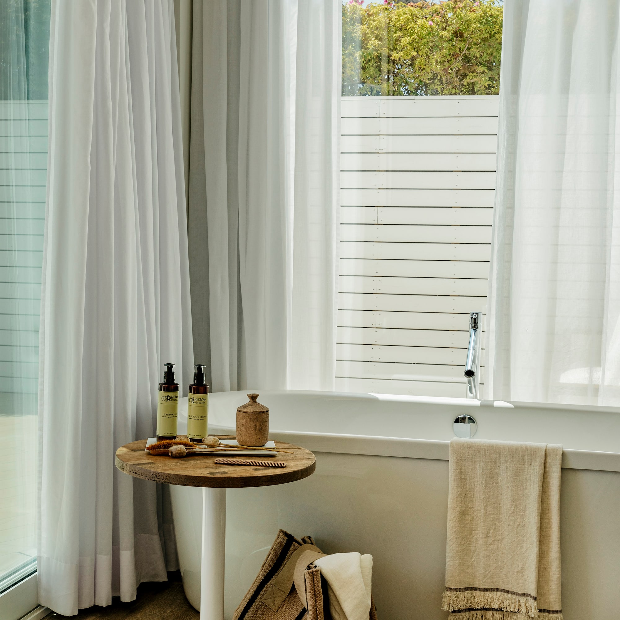 a bathroom with a tub and a table