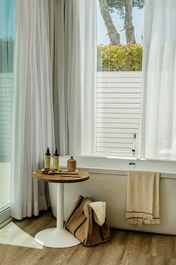a bathroom with a tub and a table