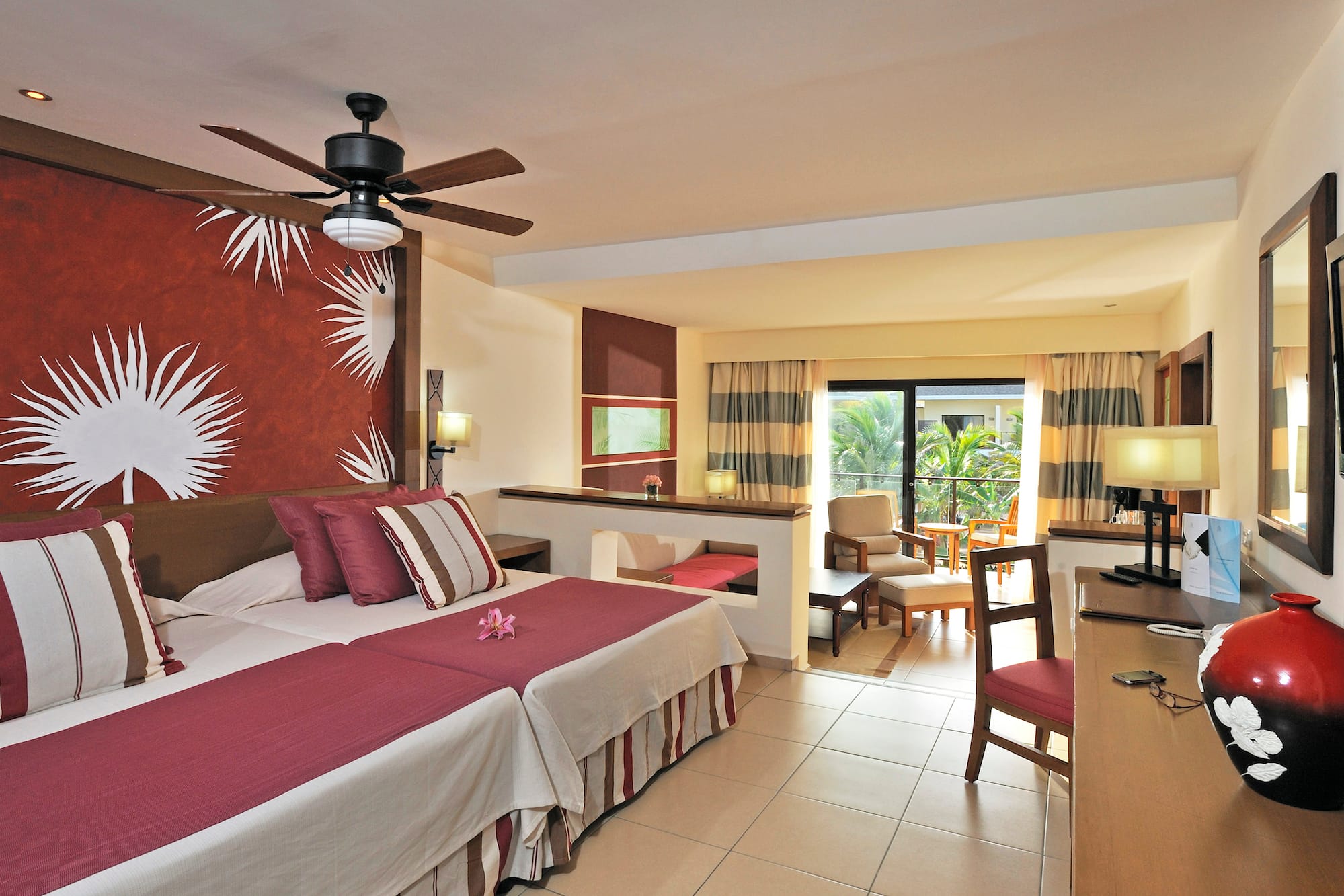 a room with two beds and a ceiling fan