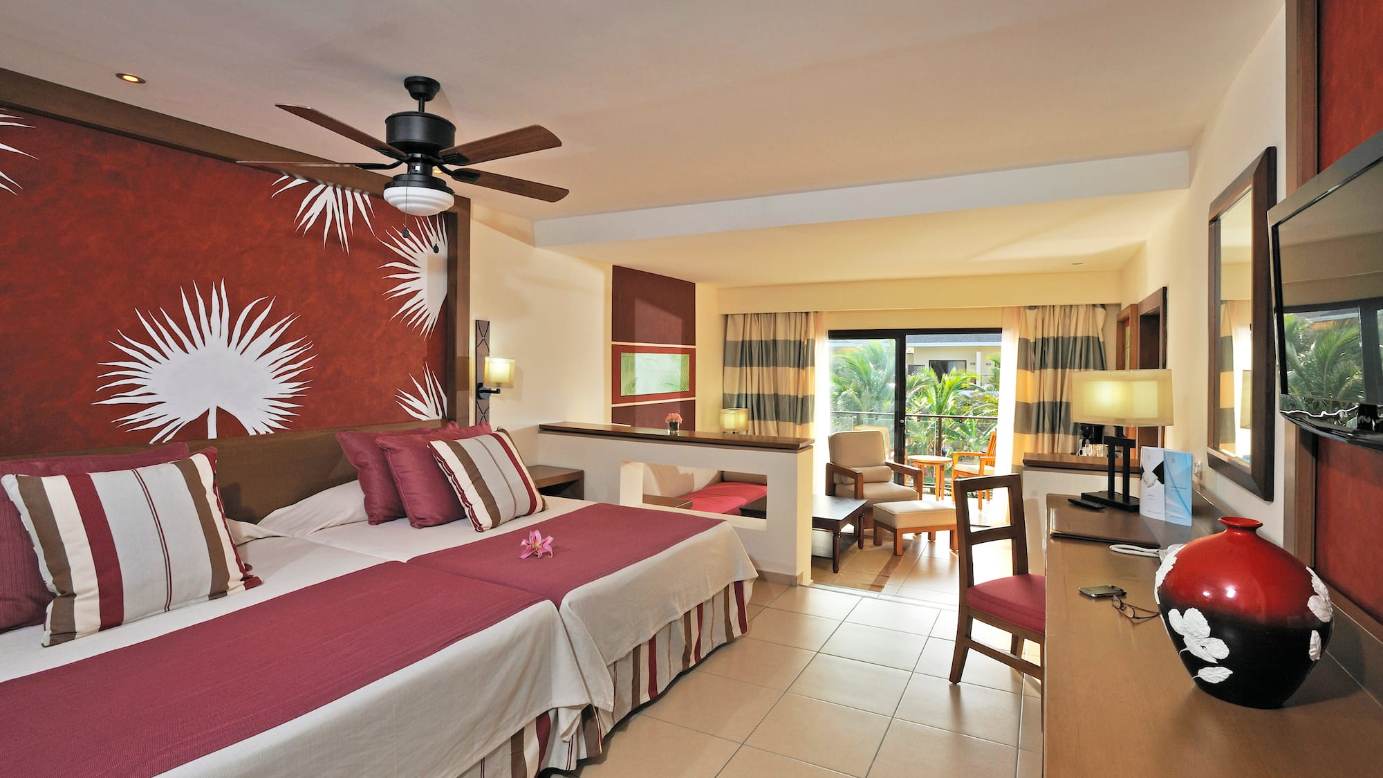 a room with two beds and a ceiling fan