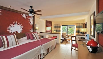 a room with two beds and a ceiling fan