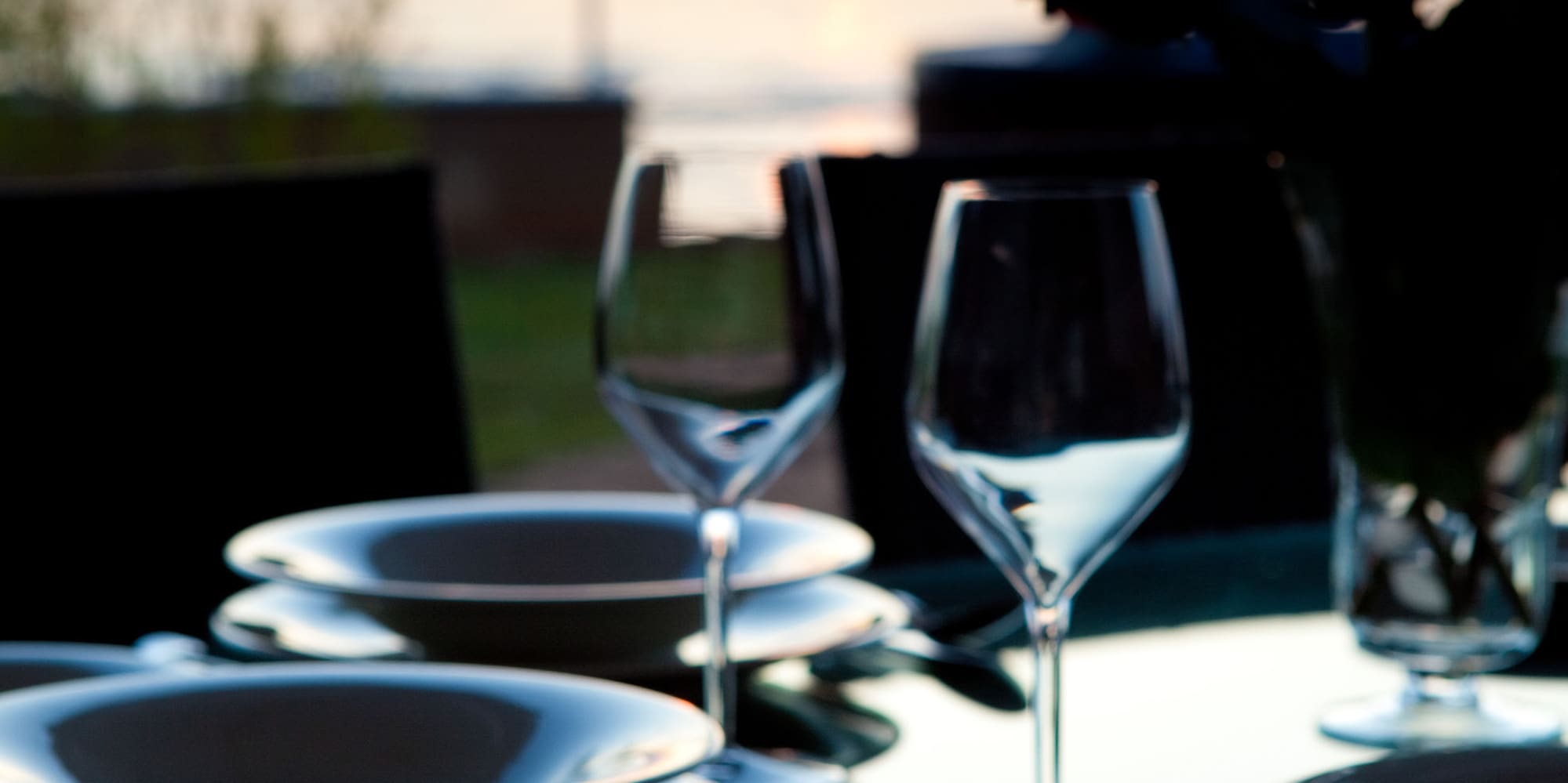 a table with plates and wine glasses on it