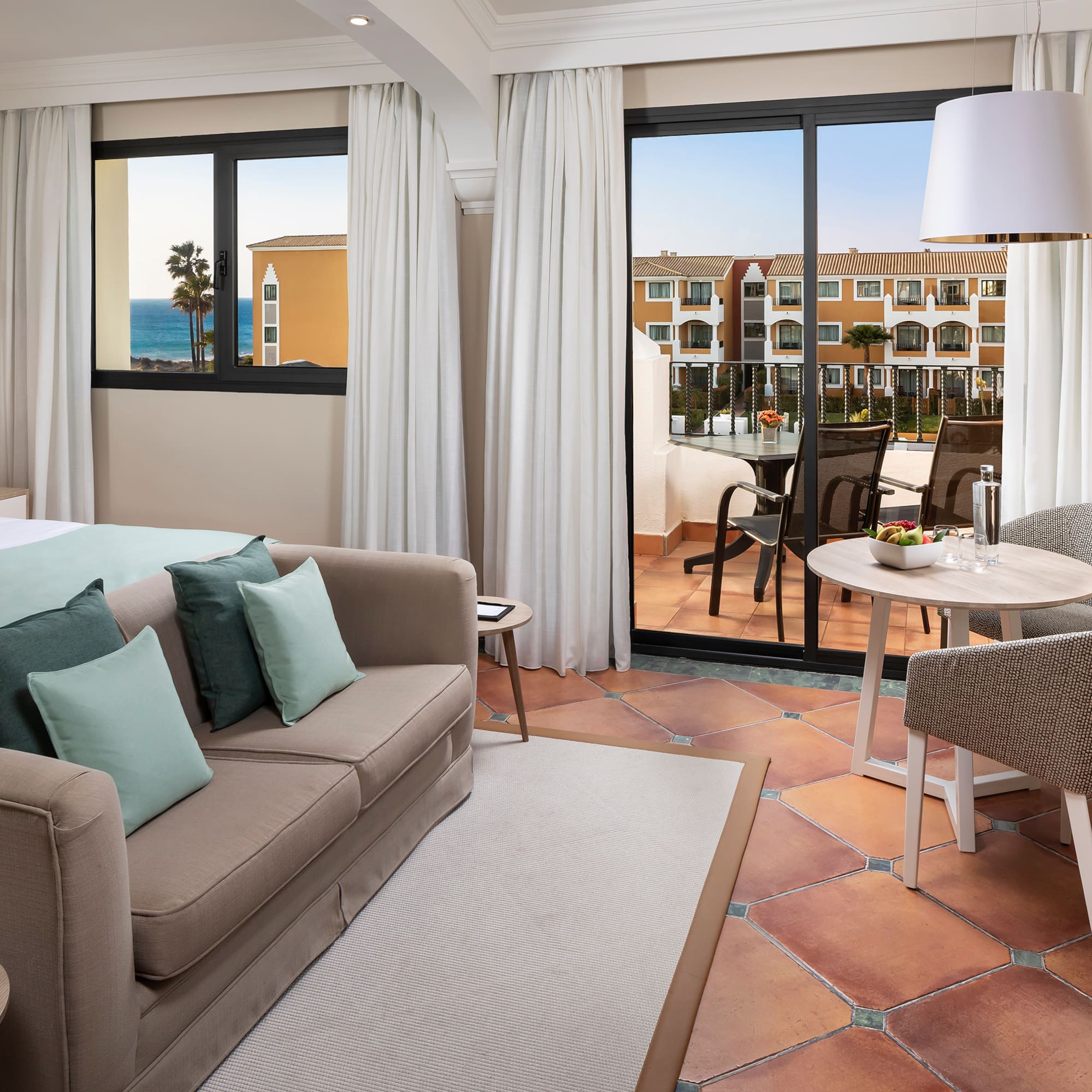 a room with a couch and a table and chairs